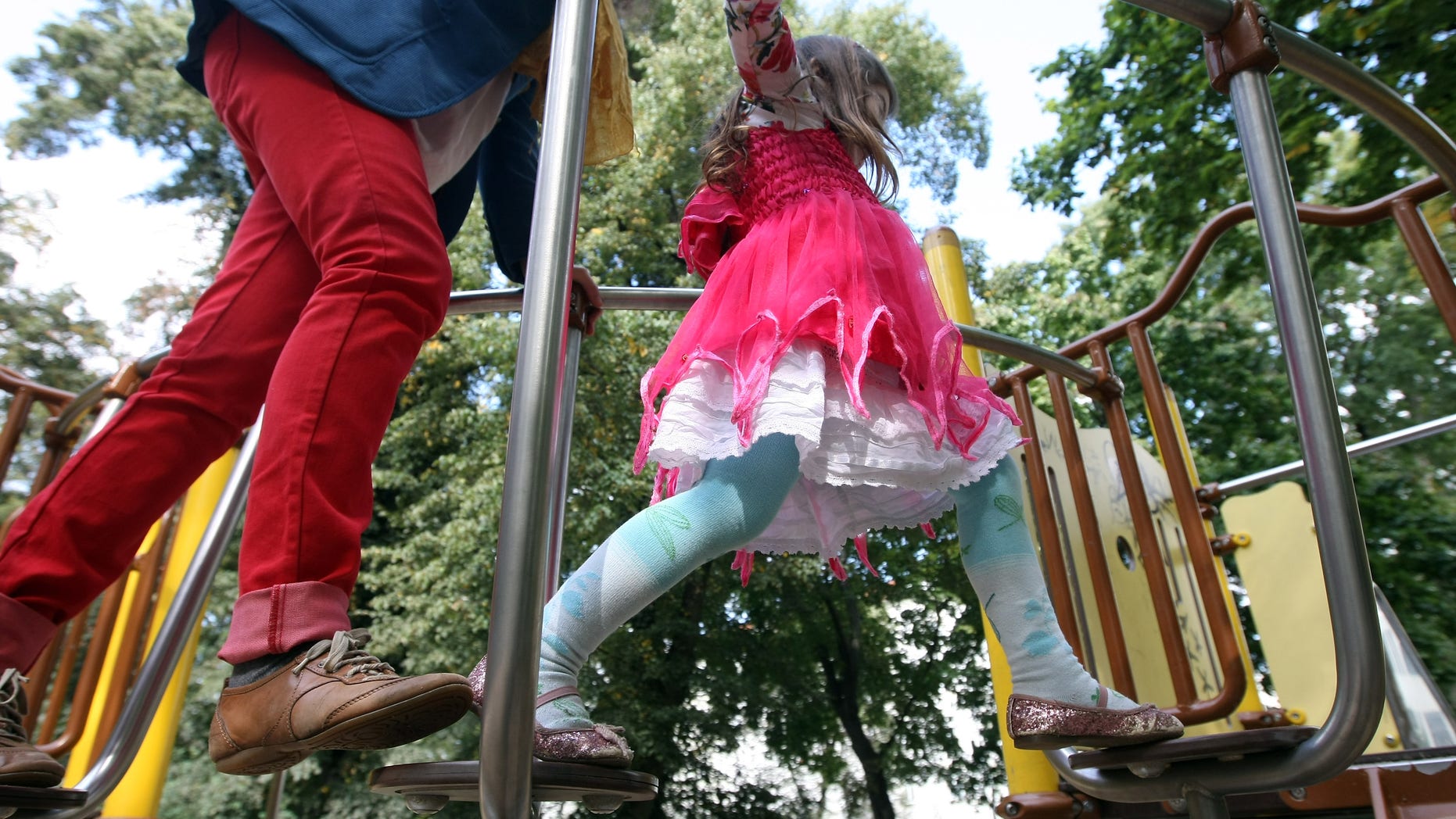 BERLIN, GERMANY - SEPTEMBER 16: A mother plays with her three-year-old daughter on a playground on September 16, 2012 in Berlin, Germany. Germany is currently debating the introduction of a nation-wide home child care subsidy (Betreuungsgeld), which would provide parents of one to three-year-old children the option of receiving EUR 150 (196.91 USD) a month to care for the child at home rather than sending him or her to a daycare center. Critics argue it would prevent the integration of children of recent immigrants into German society. (Photo by Adam Berry/Getty Images)