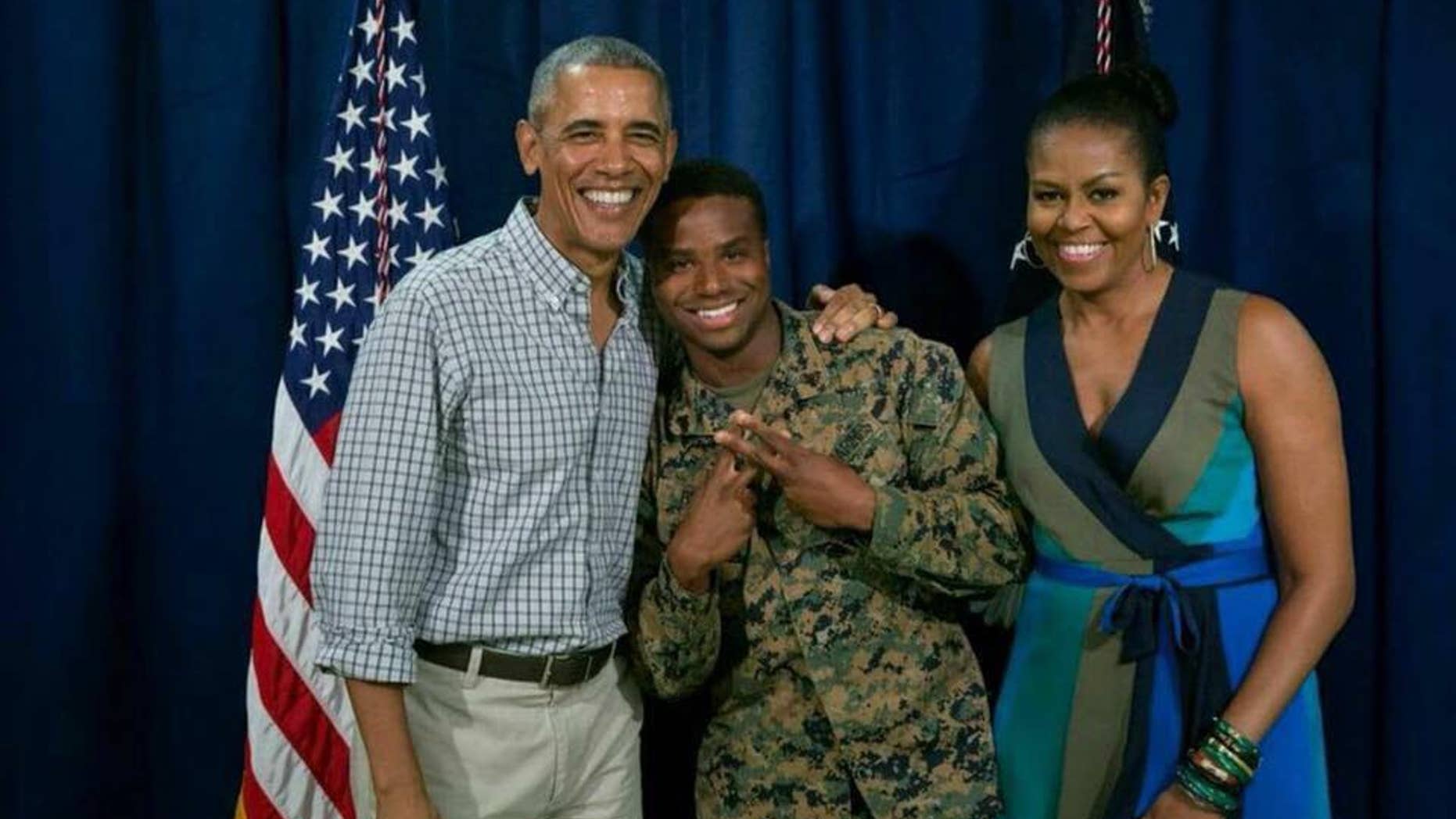 Sgt. William Brown, center, stands with former President Barack Obama and Michelle Obama.