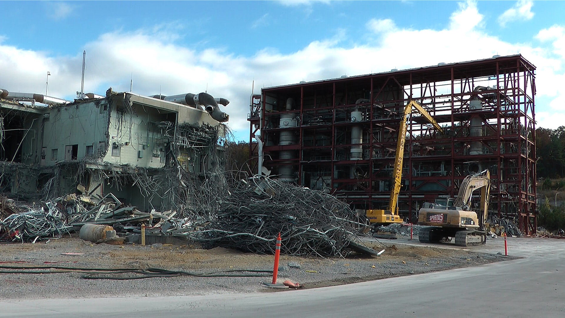 In this photo taken Tuesday, Nov. 12, 2013, workers continue the process of demolishing chemical waste incinerator at the Anniston Army Depot in Anniston, Ala. The Pentagon spent $10.2 billion over three decades burning chemical weapons stored in four states. Now, with those chemicals up in smoke and communities freed of a threat, the Army’s in the middle of another, $1.3 billion project: Demolishing the incinerators that destroyed the toxic materials. (AP Photo/Jay Reeves)
