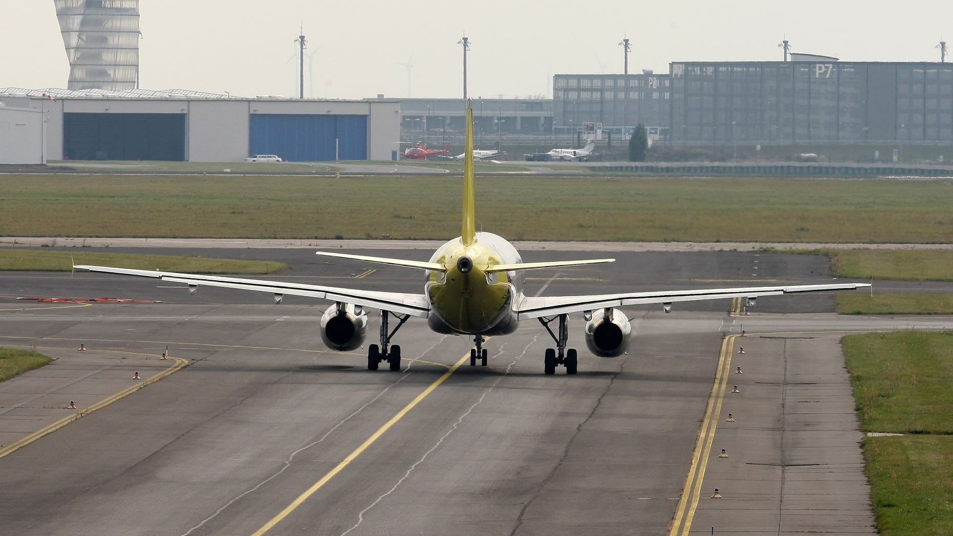 BERLIN, GERMANY - OCTOBER 12: A Germanwings airplane prepares to takes off facing the construction site of the new Willy Brandt Berlin Brandenburg International Airport (BER) at Schoenefeld airport on October 12, 2012 near Berlin, Germany. Lufthansa is merging flights with its low-cost subsidiary Germanwings in an effort to make a profit from its domestic and European routes as it competes with budget carriers. (Photo by Adam Berry/Getty Images)