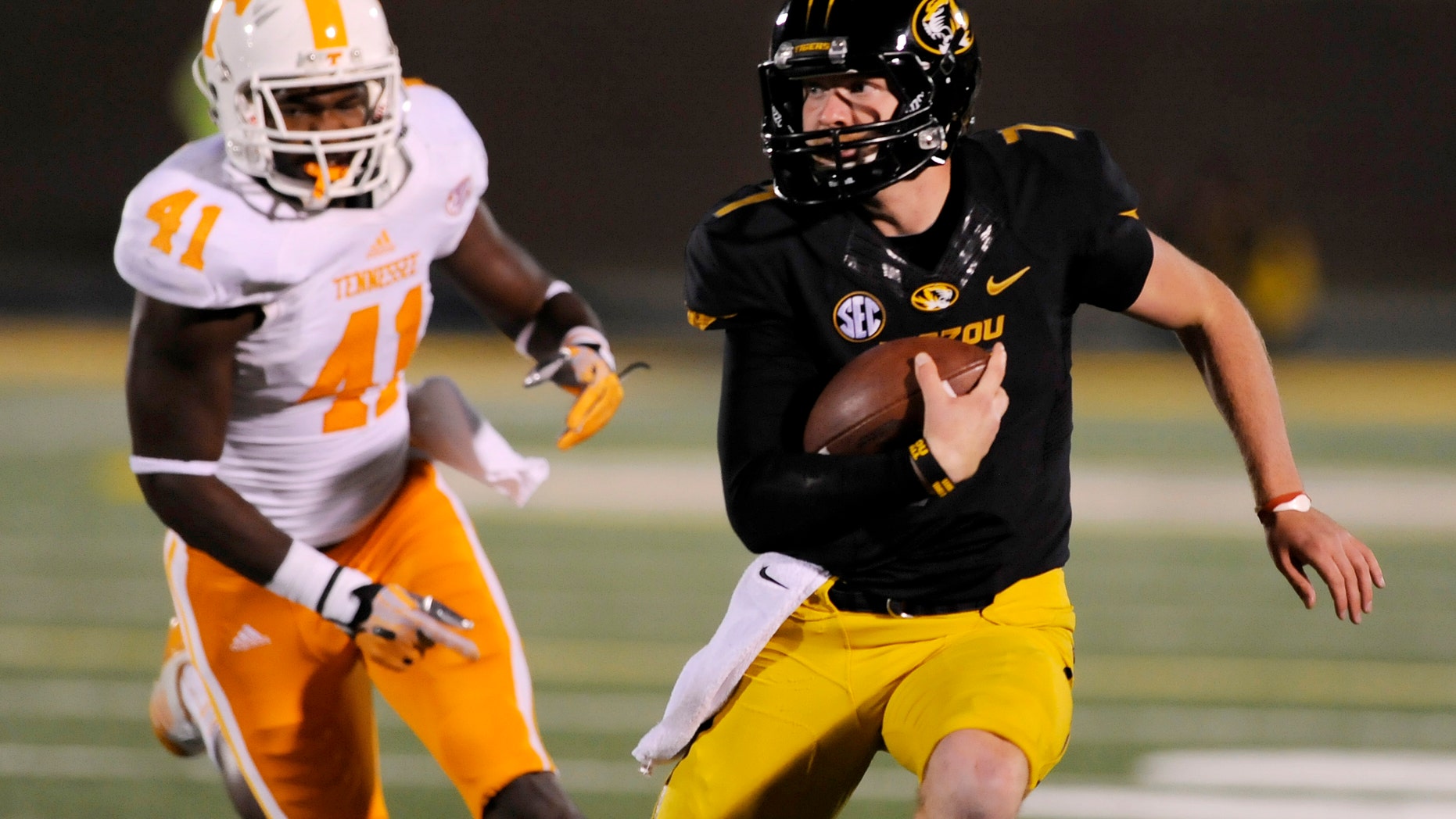 Missouri quarterback Maty Mauk, right, runs for a 19-yard gain past Tennessee linebacker Dontavis Sapp during the first half of an NCAA college football game Saturday, Nov. 2, 2013, in Columbia, Mo. (AP Photo/L.G. Patterson)