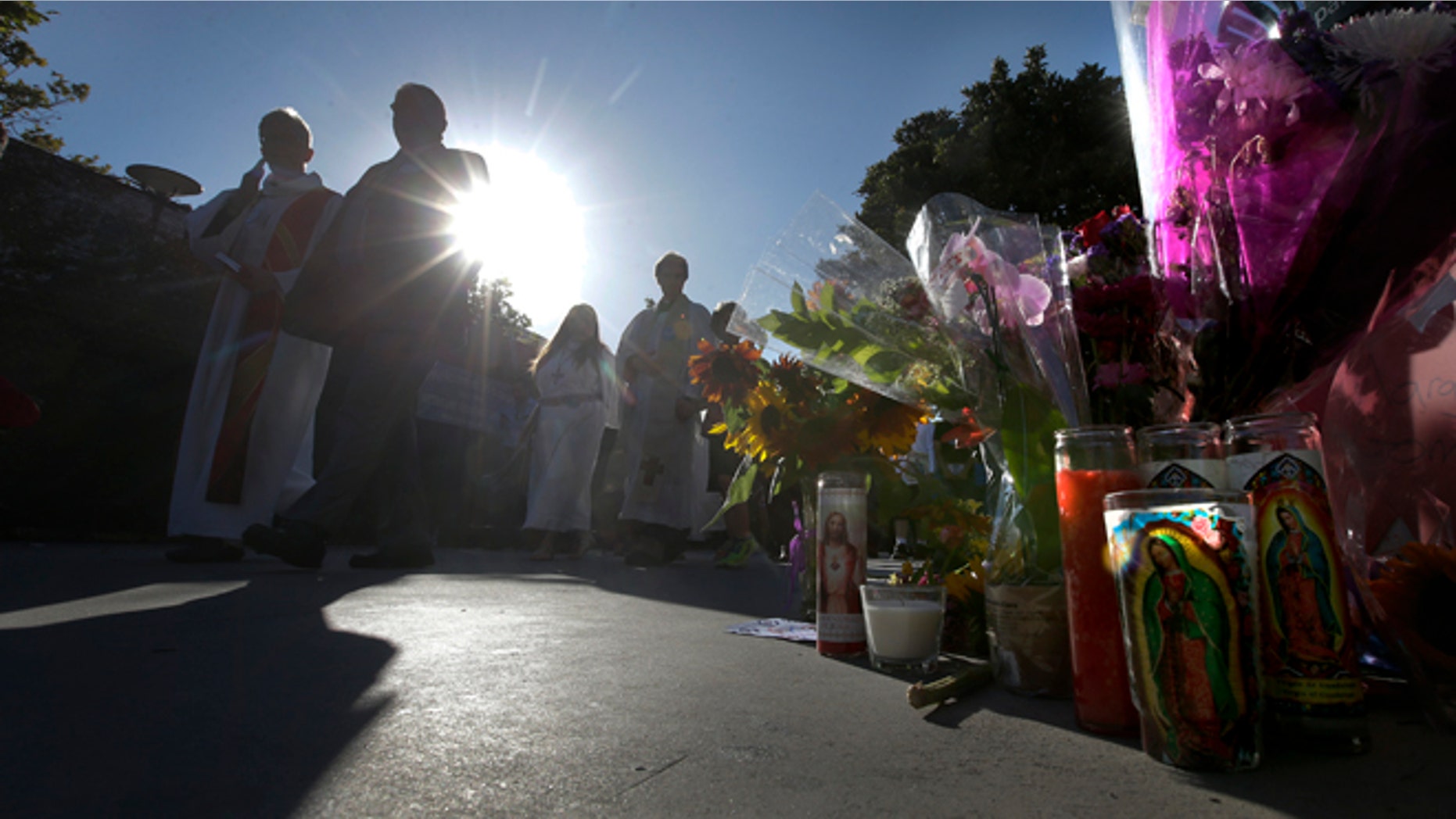 Family and friends march to Santa Monica College Corsair football stadium Monday, June 10, 2013, during a vigil for the five people killed in Friday's shootings in Santa Monica, Calif. (AP Photo/Chris Carlson)