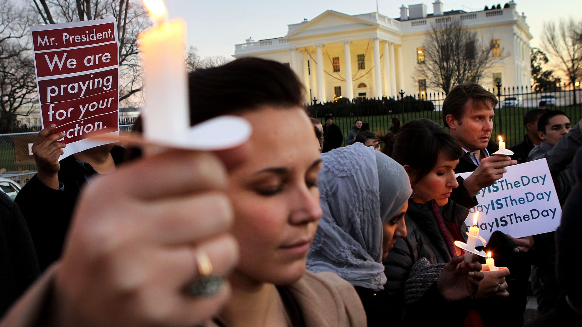 WASHINGTON, DC - DECEMBER 14: People gather outside the White House to participate in a candle light vigil to remember the victims at the Sandy Hook Elementary School shooting in Newtown, Connecticut on December 14, 2012 in Washington, DC. According to reports, there are about 27 dead, 18 children, after a gunman opened fire in at the Sandy Hook Elementary School. The shooter was also killed. (Photo by Alex Wong/Getty Images)