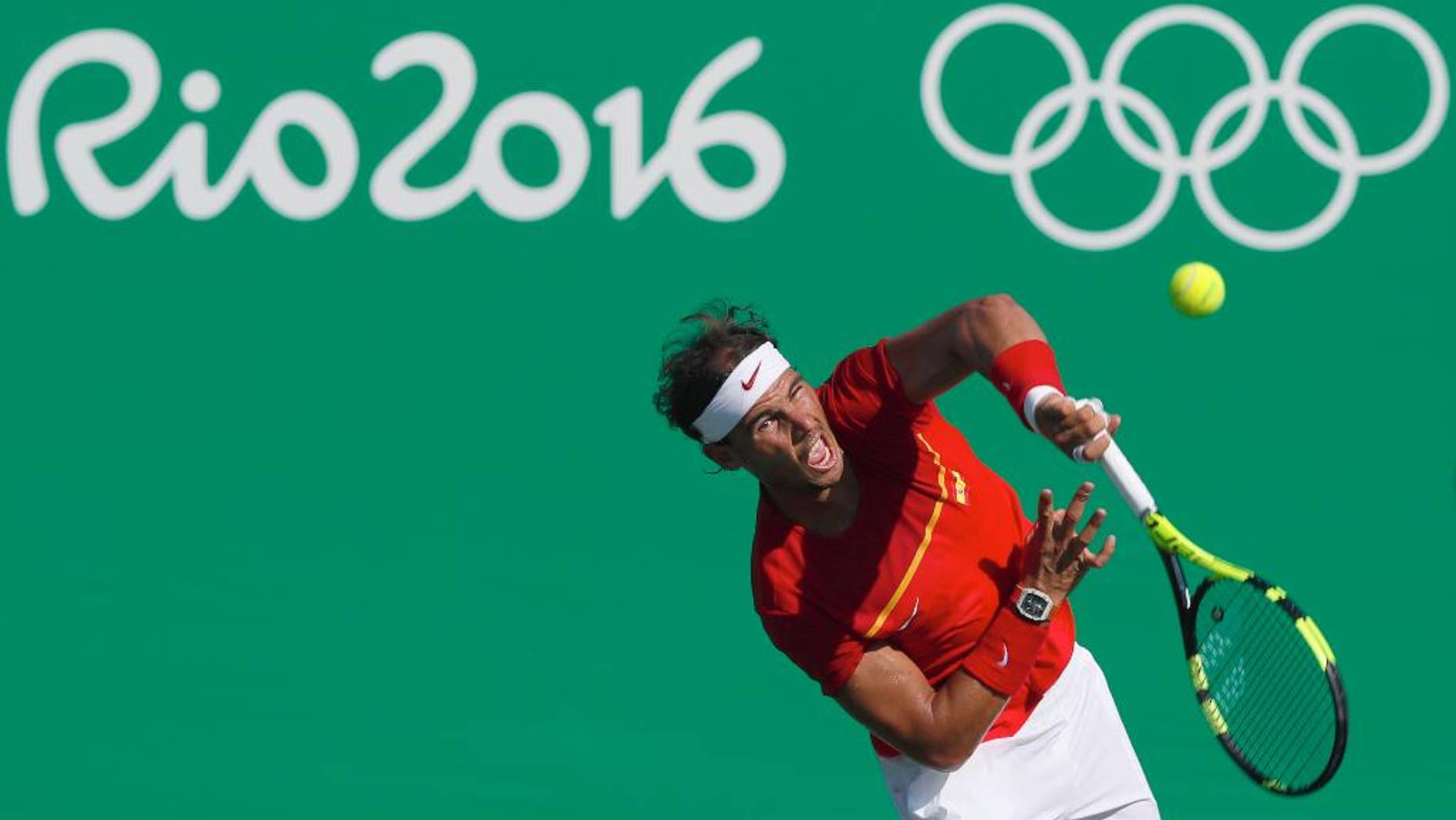 Spain's Rafael Nadal serves to Japan's Kei Nishikori during the bronze medal match of the men's tennis competition at the 2016 Summer Olympics in Rio de Janeiro, Brazil, Sunday, Aug. 14, 2016. (AP Photo/Vadim Ghirda)