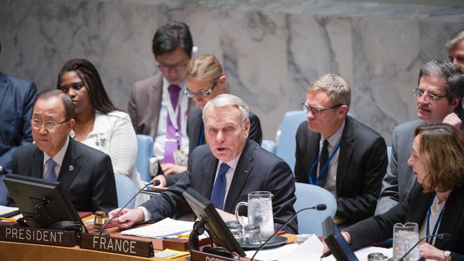In this photo provided by the United Nations, Jean-Marc Ayrault, center, Minister for Foreign Affairs and International Development of France, addresses the United Nations Security Council, Friday, June 10, 2016 at United Nations headquarters. U.N. Secretary-General Ban Ki-moon is seated to his left and Hasmik Egian, Acting Director of the Security Council Affairs Division, is to the right. Ayrault addressed a small group of reporters on Friday, warning that Israel's ban on Palestinians entering its territory following the "abominable" attack on a popular cafe in Tel Aviv could escalate violence instead of focus attention on the need to pursue peace. (Rick Bajornas/The United Nations via AP)