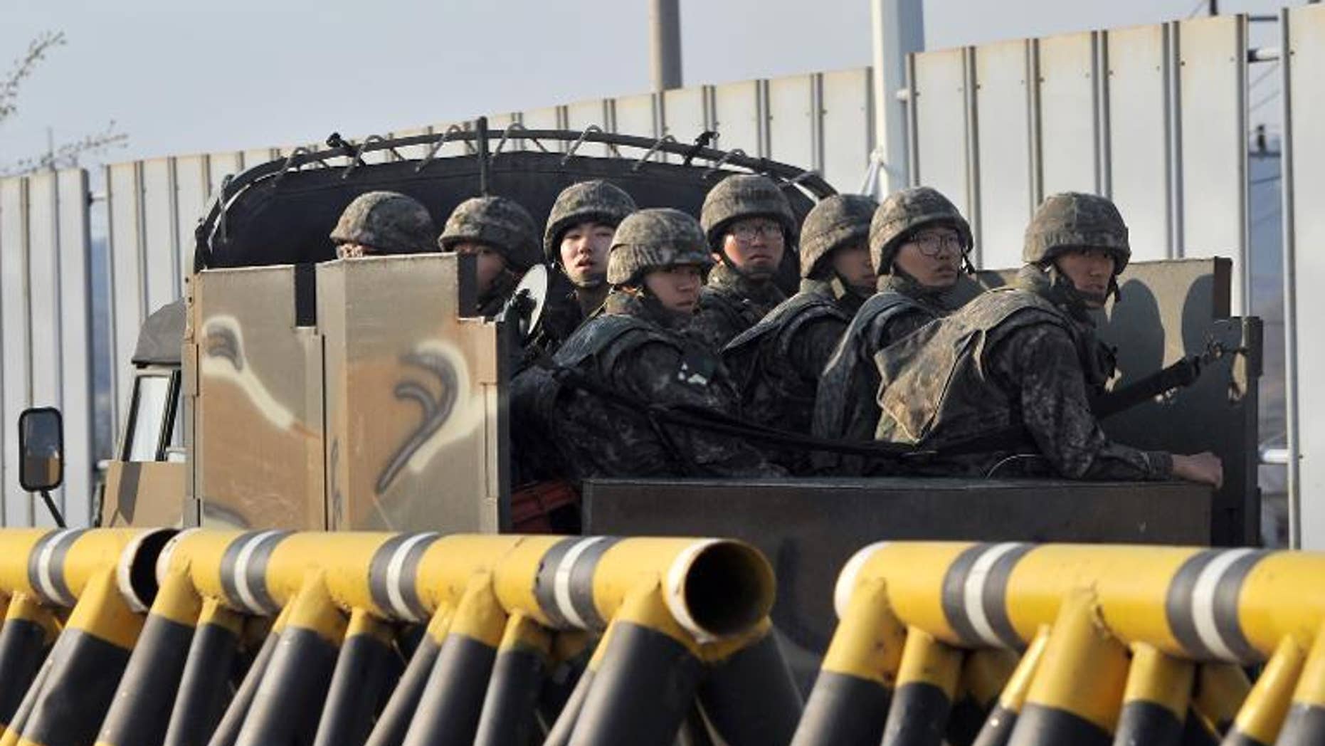 South Korean soldiers ride a military vehicle on the road leading to North Korea in the border city of Paju on April 26, 2013.