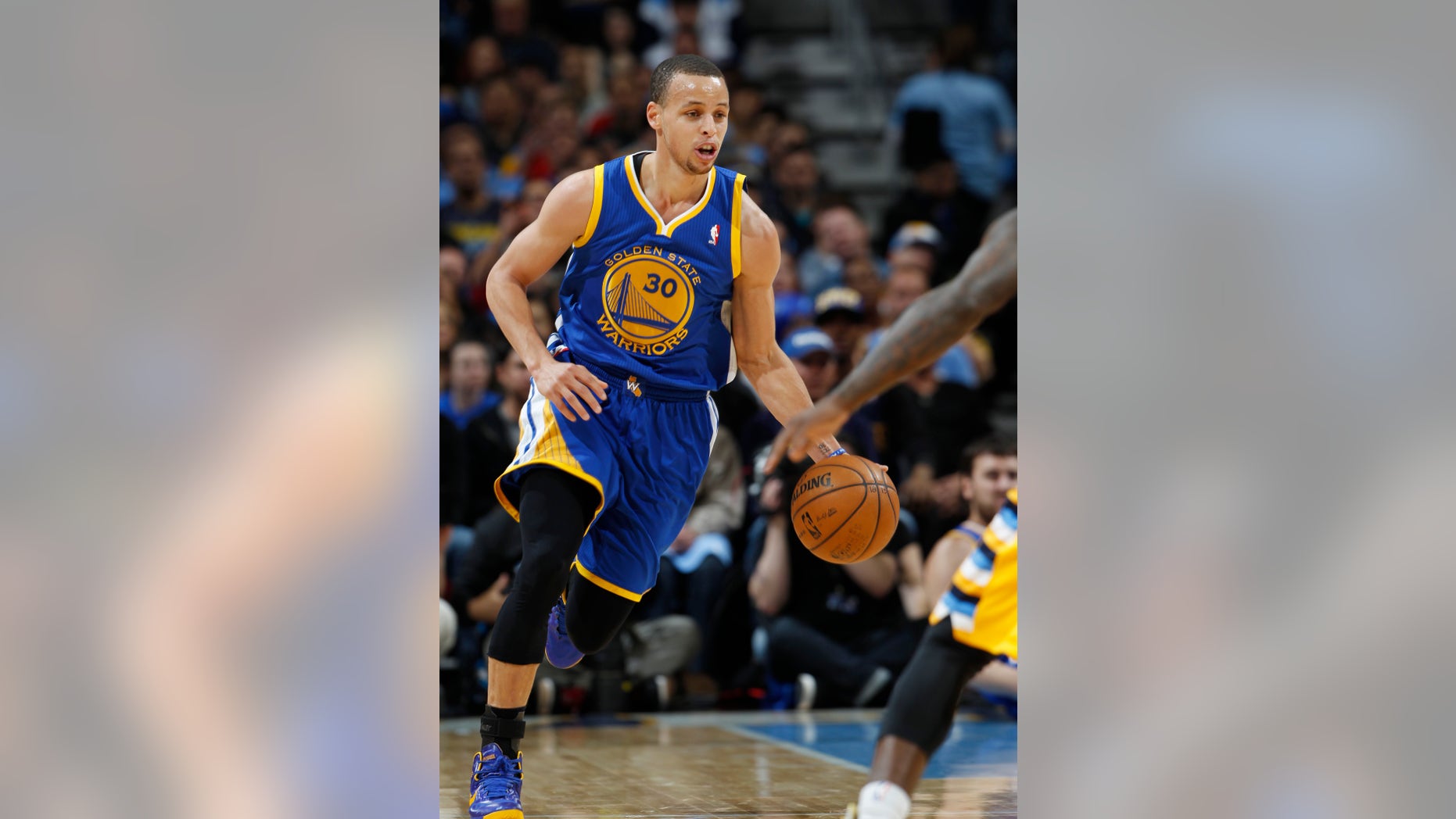Golden State Warriors guard Stephen Curry picks up a loose ball against the Denver Nuggets in the first quarter of Game 2 of the teams' NBA first-round playoff series in Denver on Tuesday, April 23, 2013. (AP Photo/David Zalubowski)