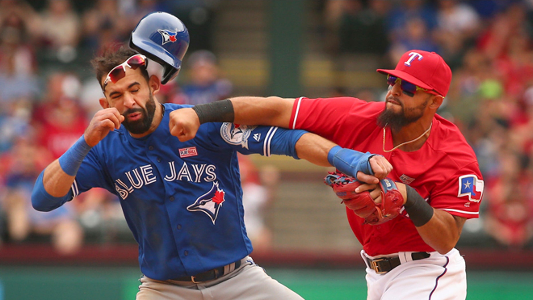 Toronto Blue Jays Jose Bautista (19) gets hit by Texas Rangers second baseman Rougned Odor (12) after Bautista slid into second in the eighth inning of a baseball game at Globe Life Park in Arlington, Texas, Sunday May 15, 2016. (Richard W. Rodriguez/Star-Telegram via AP)