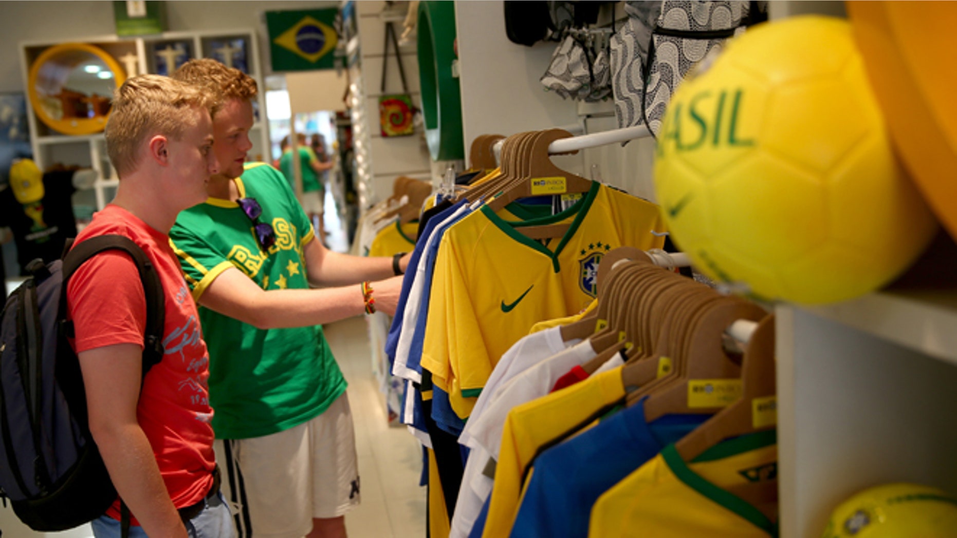 RIO DE JANEIRO, BRAZIL - JUNE 09: George Mackenzie Smith and Tom Simmonds ,both from Scotland, shop for World Cup souvenirs in a Rio in Box store on June 9, 2014 in Rio de Janeiro, Brazil. Brazil continues to prepare to host the World Cup which starts on June 12th and runs through July 13th. (Photo by Joe Raedle/Getty Images)