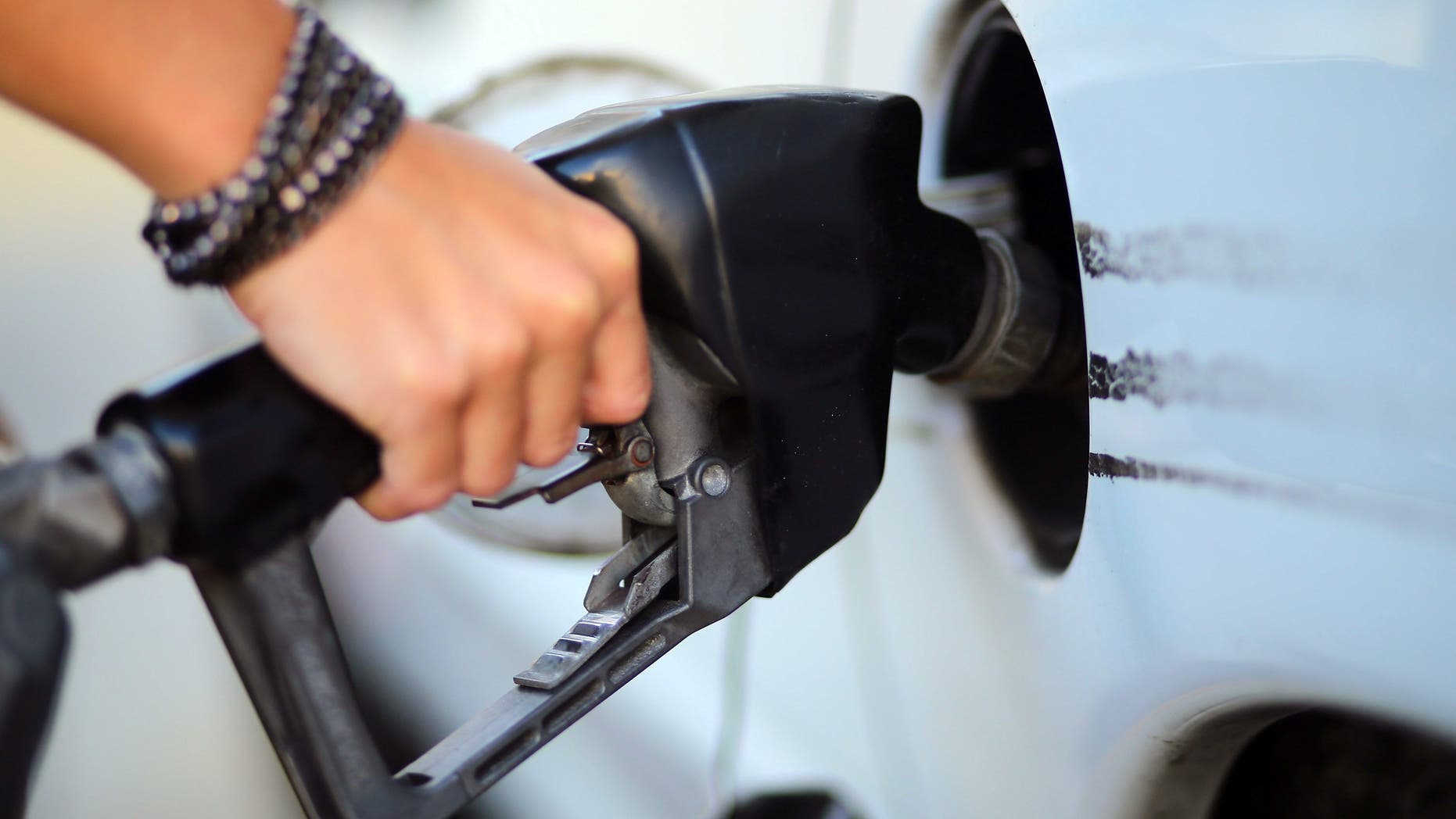 A driver pumps gas in Miami, in Feb. 2013. Prices at the pump reached their lowest level in two years in December at $2.37 and have continued to fall, according to FOX Business. (Getty Images)
