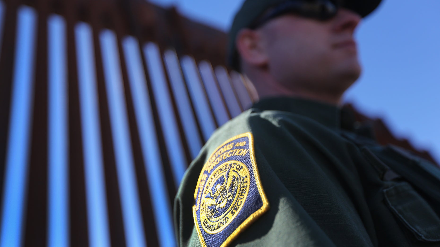 NOGALES, AZ - FEBRUARY 26: A U.S. Border Patrol agent stands at the U.S.-Mexico border fence on February 26, 2013 in Nogales, Arizona. Various federal agencies are tasked with securing the border from drug smugglers and illegal immigration in the Tucson sector of Arizona. (Photo by John Moore/Getty Images)
