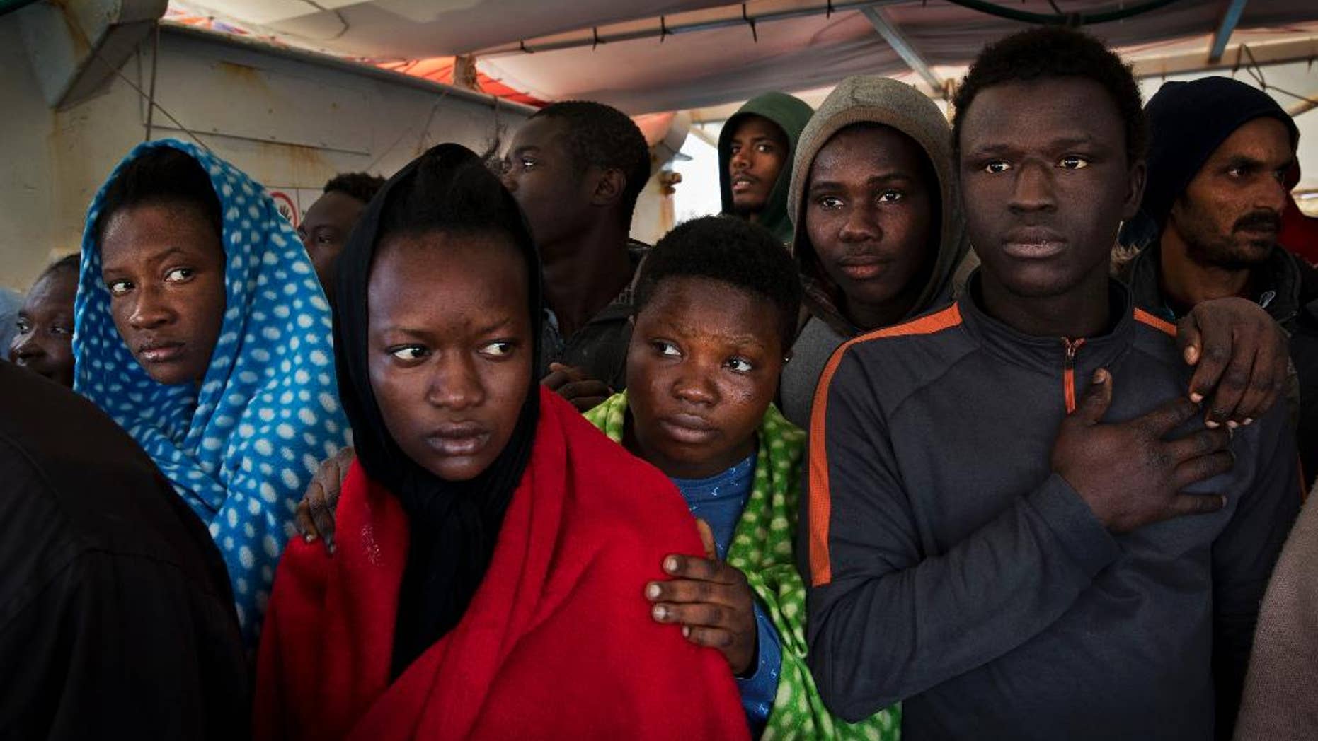 FILE - In this April 8, 2017 file photo, migrants aboard the Golfo Azurro rescue vessel wait to be transferred to Italian authorities in Trapani harbor, in the Italian island of Sicily. Most, though, don't understand that this could be just one more step in an impossible dream. Many are sent to government-run migrant camps. Others, depending on international agreements, are sent back home. (AP Photo/Bernat Armangue, File)