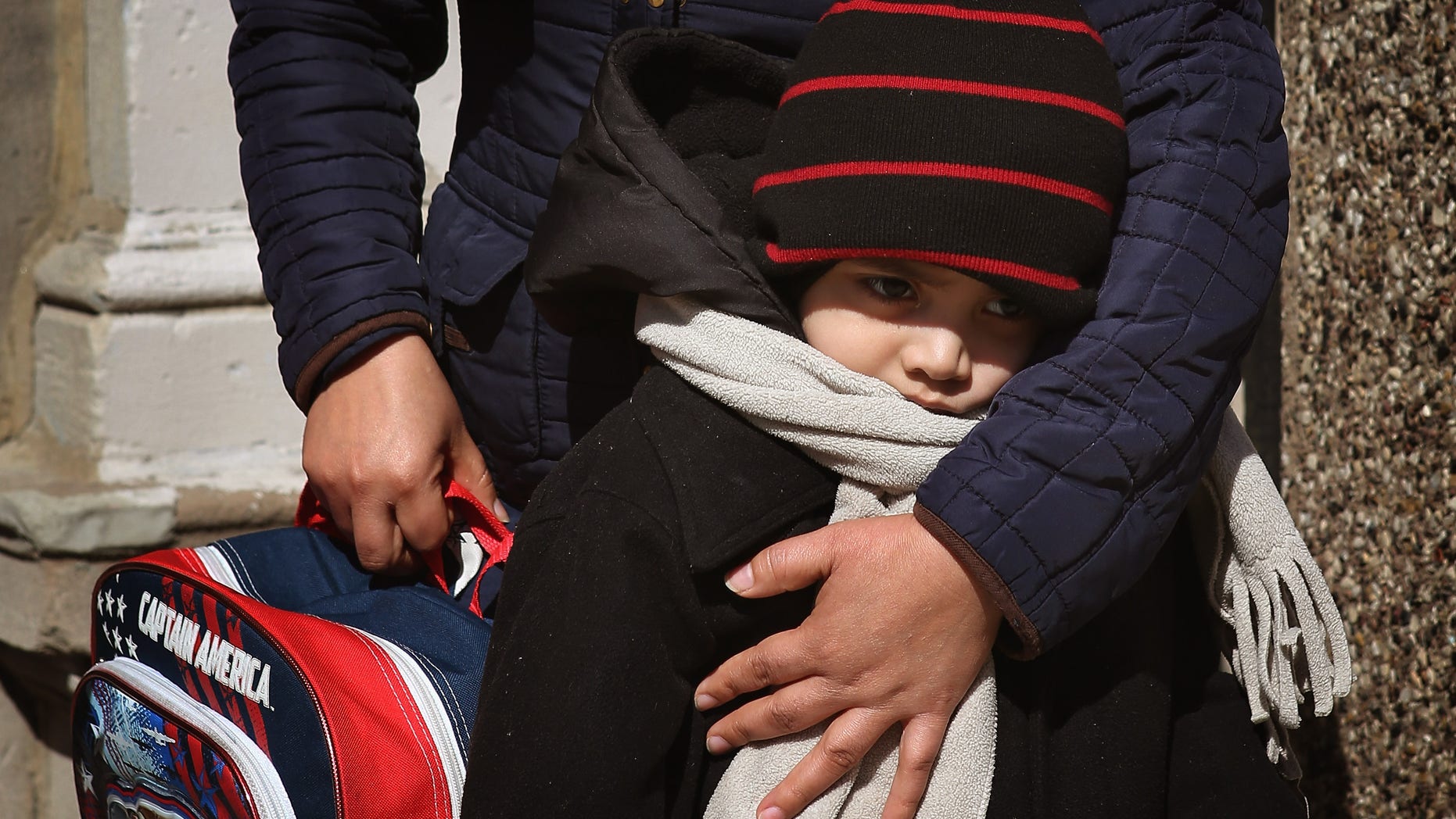 CHICAGO, IL - MARCH 21: Five-year-old Juan Carlos Ordonez gets a hug from his mother as she meets him after school at the Jean De Lafayette Elementary School where he attends the low incidence special education program on March 21, 2013 in Chicago, Illinois. Low incidence special education Programs are educational programs for students with Autism or severe and profound disabilities. About 170 of Lafayette's 480 students are in the low incidence program. The school is one of 50 schools slated to be closed by the city. The school district says it needs to close under-enrolled schools to address a looming $1 billion budget deficit. Opponents of the closings are accusing the city of targeting schools primarily in minority neighborhoods. The student population at Lafayette is around 60 percent Hispanic and 35 percent black. (Photo by Scott Olson/Getty Images)