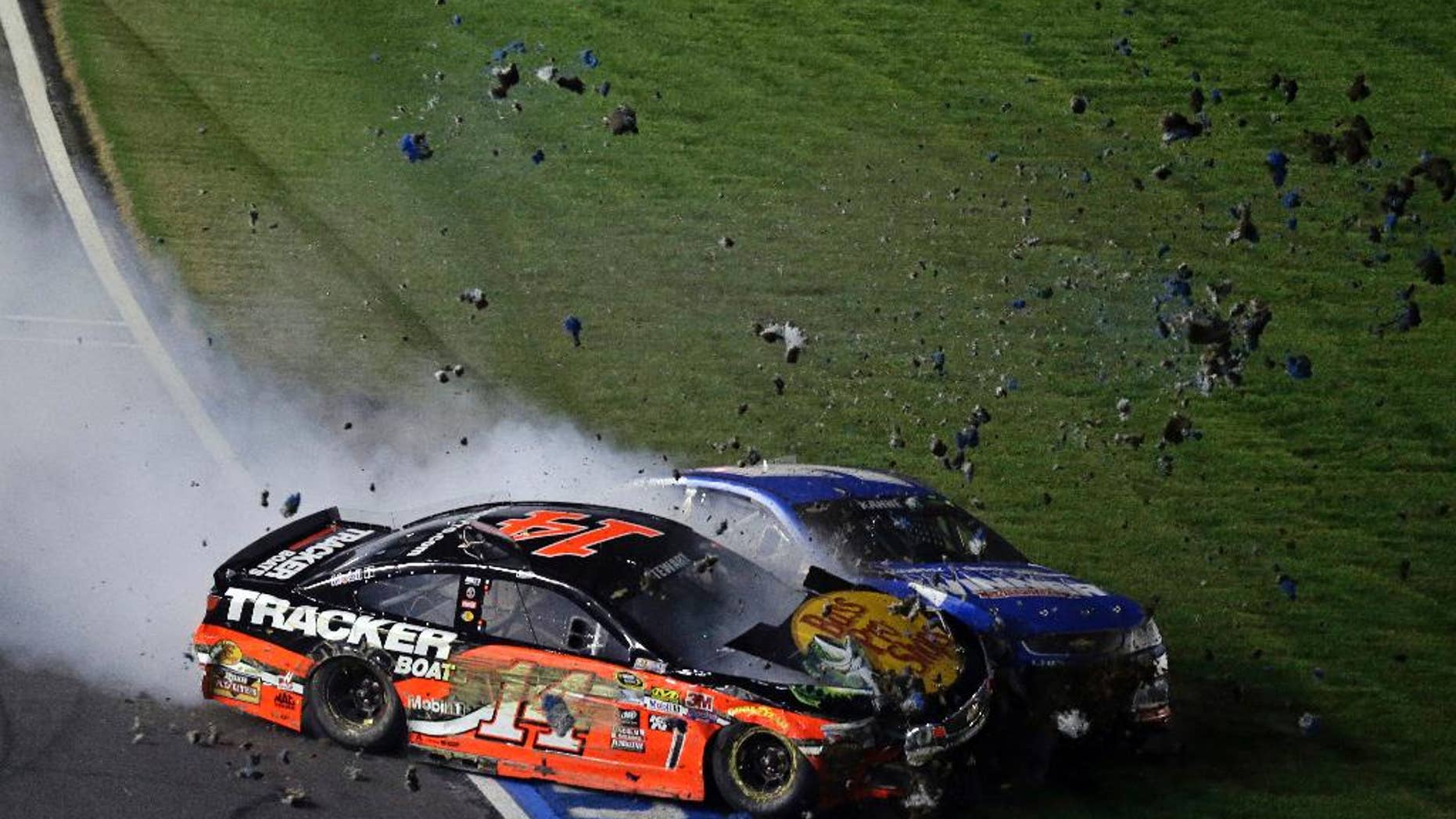 Tony Stewart (14) collides with Kasey Kahne on the front stretch during the NASCAR Sprint All-Star auto race at Charlotte Motor Speedway in Concord, N.C., Saturday, May 21, 2016. (AP Photo/Gerry Broome)