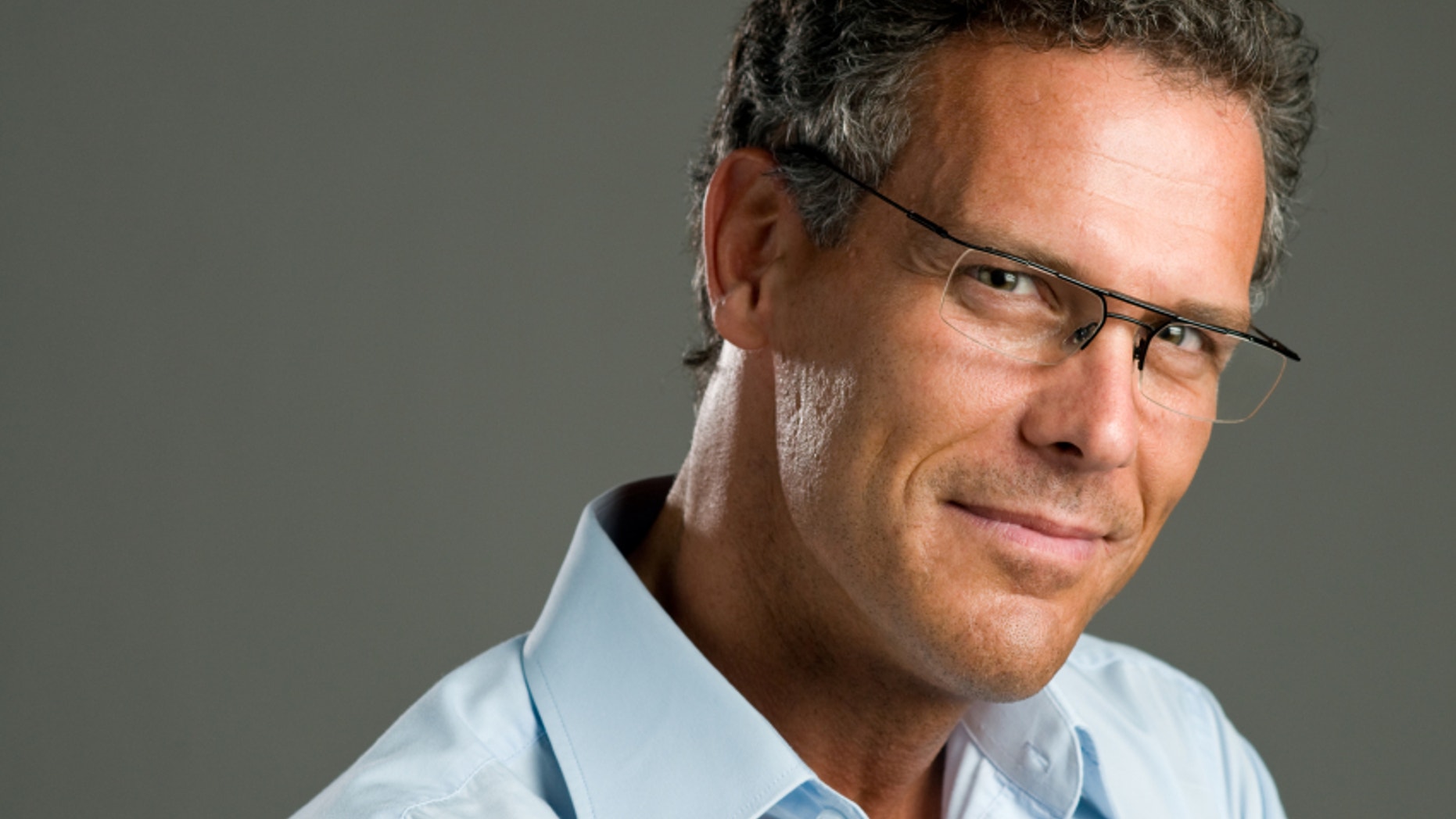 Handsome mature man looking at camera with a pair of modern glasses