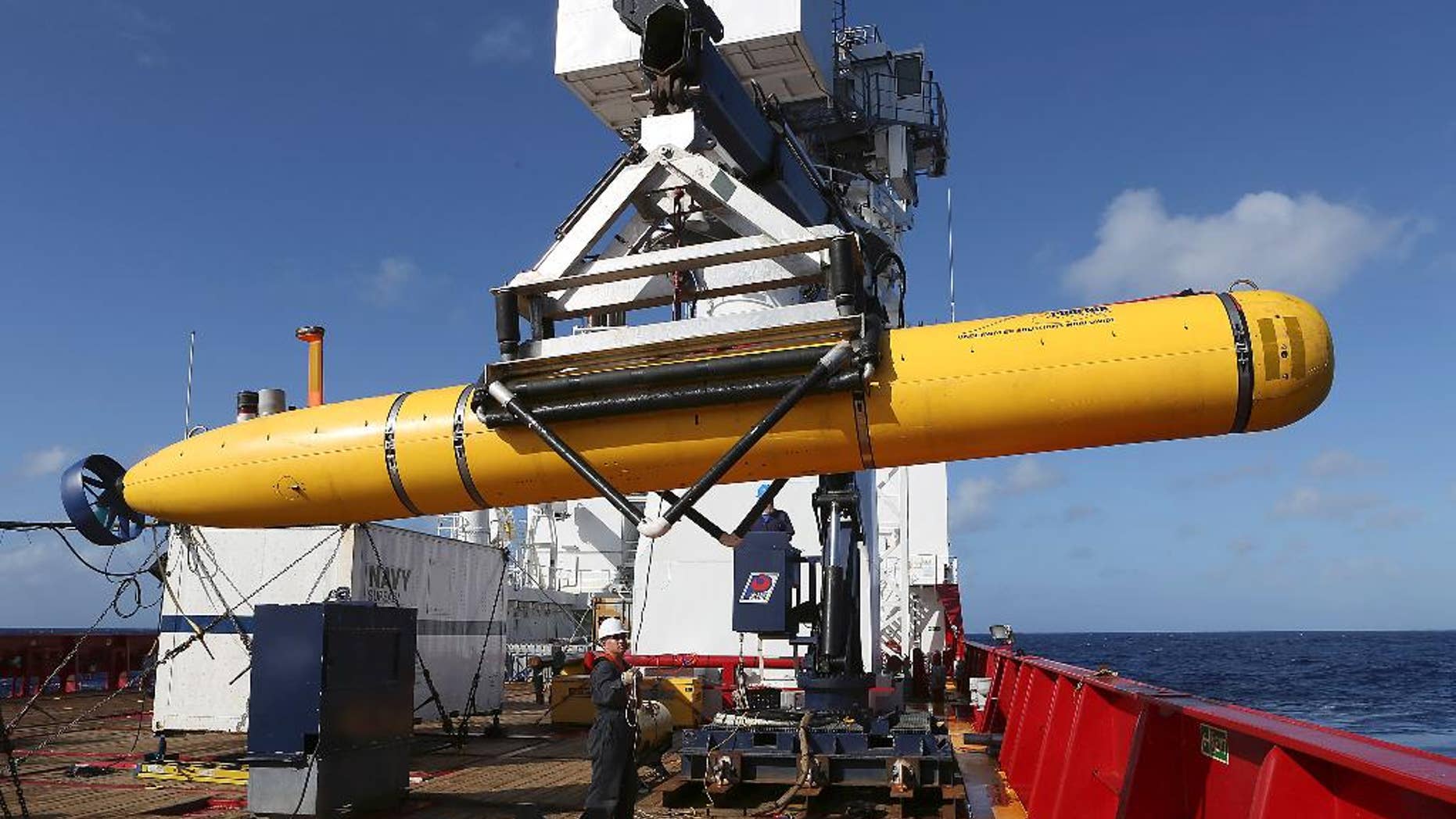 In this Thursday, April 17, 2014 photo provided by the Australian Defense Force the Phoenix International Autonomous Underwater Vehicle (AUV) Artemis is craned over the side of Australian Defense Vessel Ocean Shield before launching the vehicle into the southern Indian Ocean in the search of the missing Malaysia Airlines Flight 370. Up to 11 aircraft and 12 ships continue to scan the ocean surface for debris from the Boeing 777 that disappeared March 8 en route from Kuala Lumpur to Beijing with 239 people on board. (AP Photo/Australian Defense Force, Bradley Darvill) EDITORIAL USE ONLY