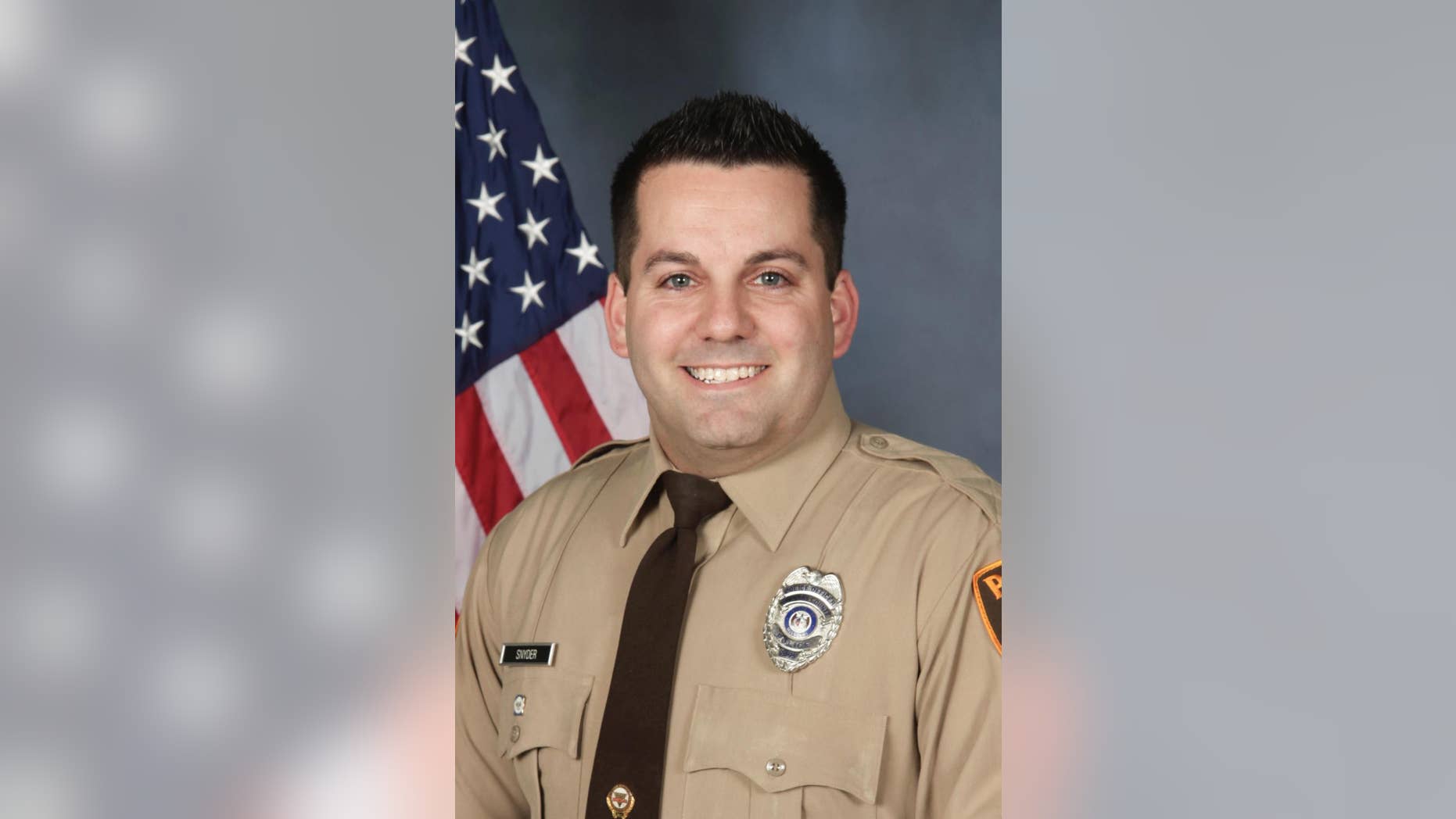 An undated photo provided by the St. Louis County Police Department shows St. Louis County Police officer Blake Snyder. Police say 33-year-old white officer Blake Snyder was fatally wounded during a pre-dawn shooting Thursday, Oct. 6, 2016, in Green Park, Mo., a small middle-class community. Police say the suspect, an 18-year-old white male, is in critical but stable condition after being shot by another officer. (St. Louis County Police Department via AP)