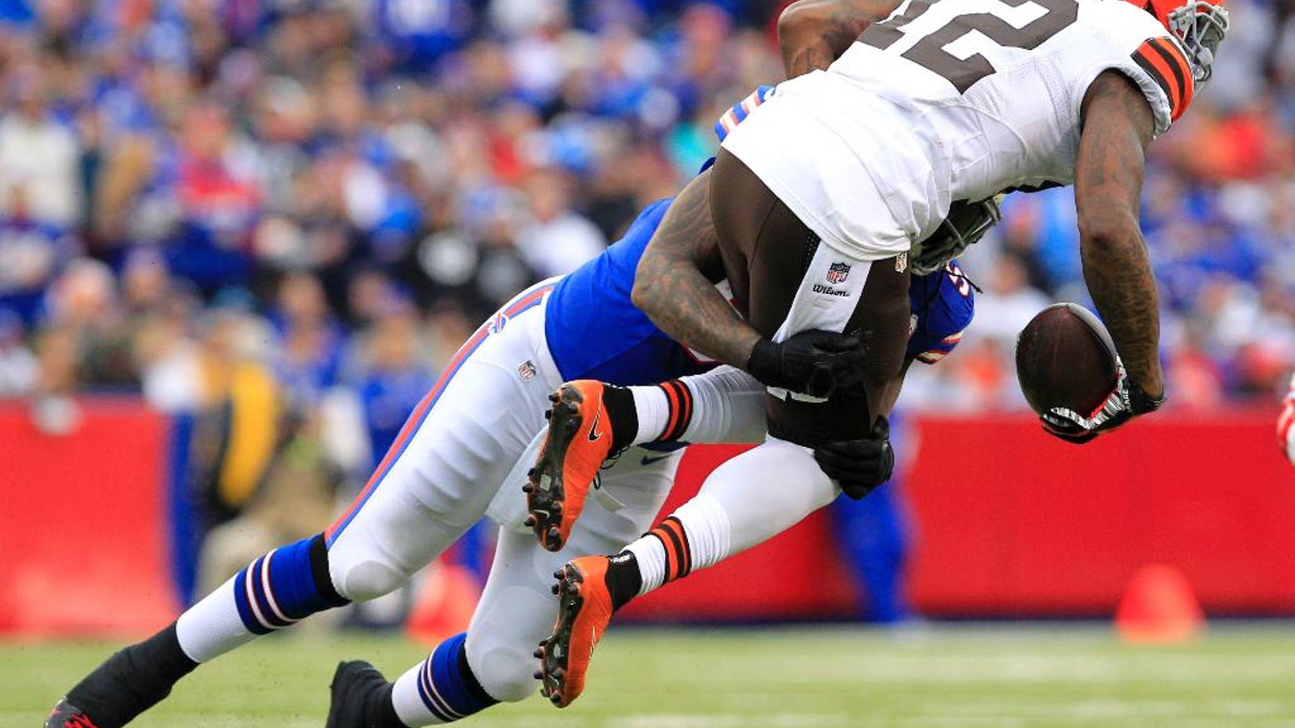 Cleveland Browns wide receiver Josh Gordon, right, is hit by Buffalo Bills middle linebacker Brandon Spike during the first half of an NFL football game, Sunday, Nov. 30, 2014, in Orchard Park, N.J. (AP Photo/Bill Wippert)