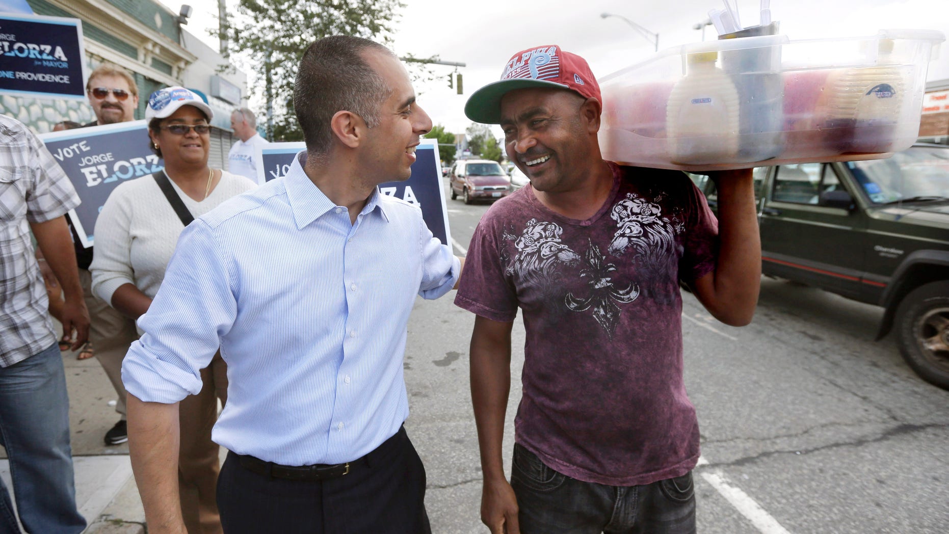 Jorge Elorza, Democratic candidate for mayor of Providence, R.I., front left, greets worker Cayetano Cepeda.