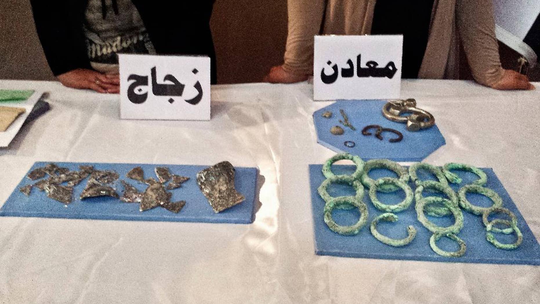 Recovered antiquities are displayed at the Iraqi National Museum in Baghdad, Iraq, Wednesday, July 15, 2015. Nearly 500 artifacts recovered by U.S. Army commandos during a recent raid in Syria targeting the Islamic State group were displayed at the Baghdad National Museum Wednesday after being returned to Iraq. (AP Photo/Vivian Salama)
