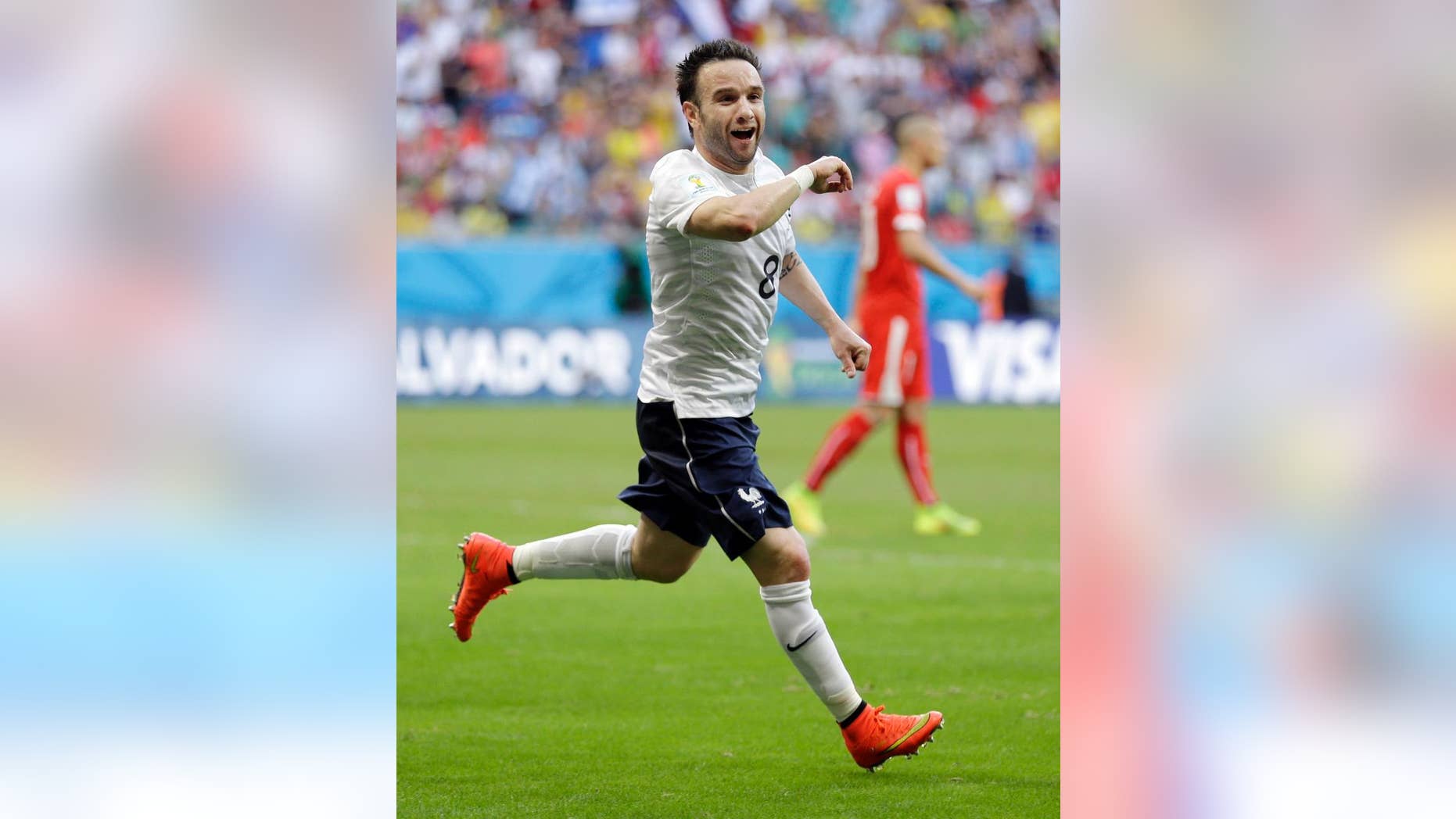 France's Mathieu Valbuena celebrates after scoring his side's third goal during the group E World Cup soccer match between Switzerland and France at the Arena Fonte Nova in Salvador, Brazil, Friday, June 20, 2014. (AP Photo/Natacha Pisarenko)