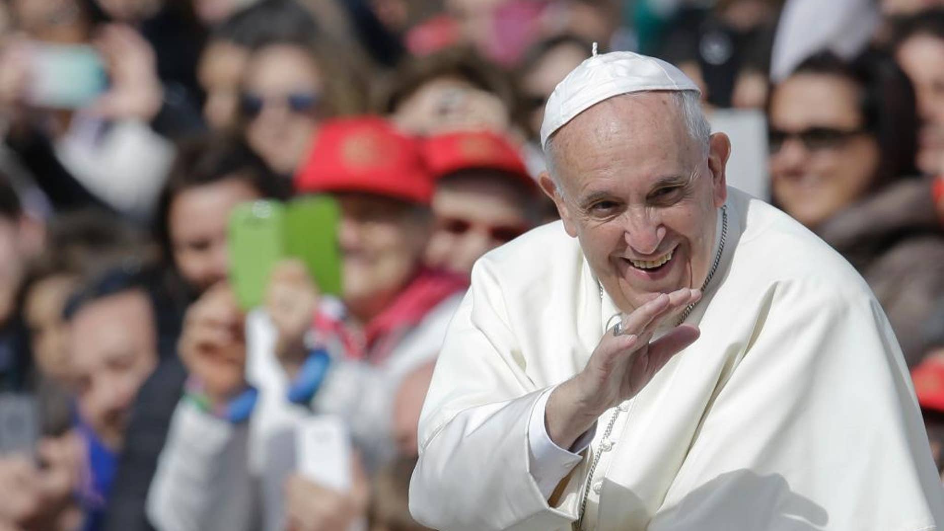 Pope Francis smiles as he blesses faithful upon his arrival in St. Peter's Square to attend a jubilee audience at the Vatican, Saturday, April 9, 2016. Pope Francis said Friday that Catholics should look to their own consciences rather than rely exclusively on church rules to negotiate the complexities of sex, marriage and family life, demanding the church shift emphasis from doctrine to mercy in confronting some of the thorniest issues facing the faithful. (AP Photo/Gregorio Borgia)