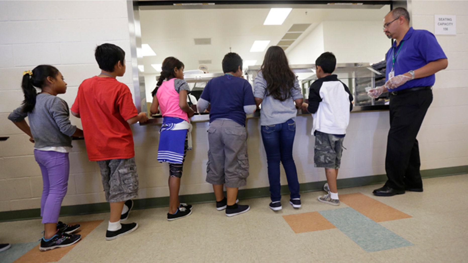 Detained immigrant children line up in the cafeteria at the Karnes County Residential Center, in Karnes City, Texas.