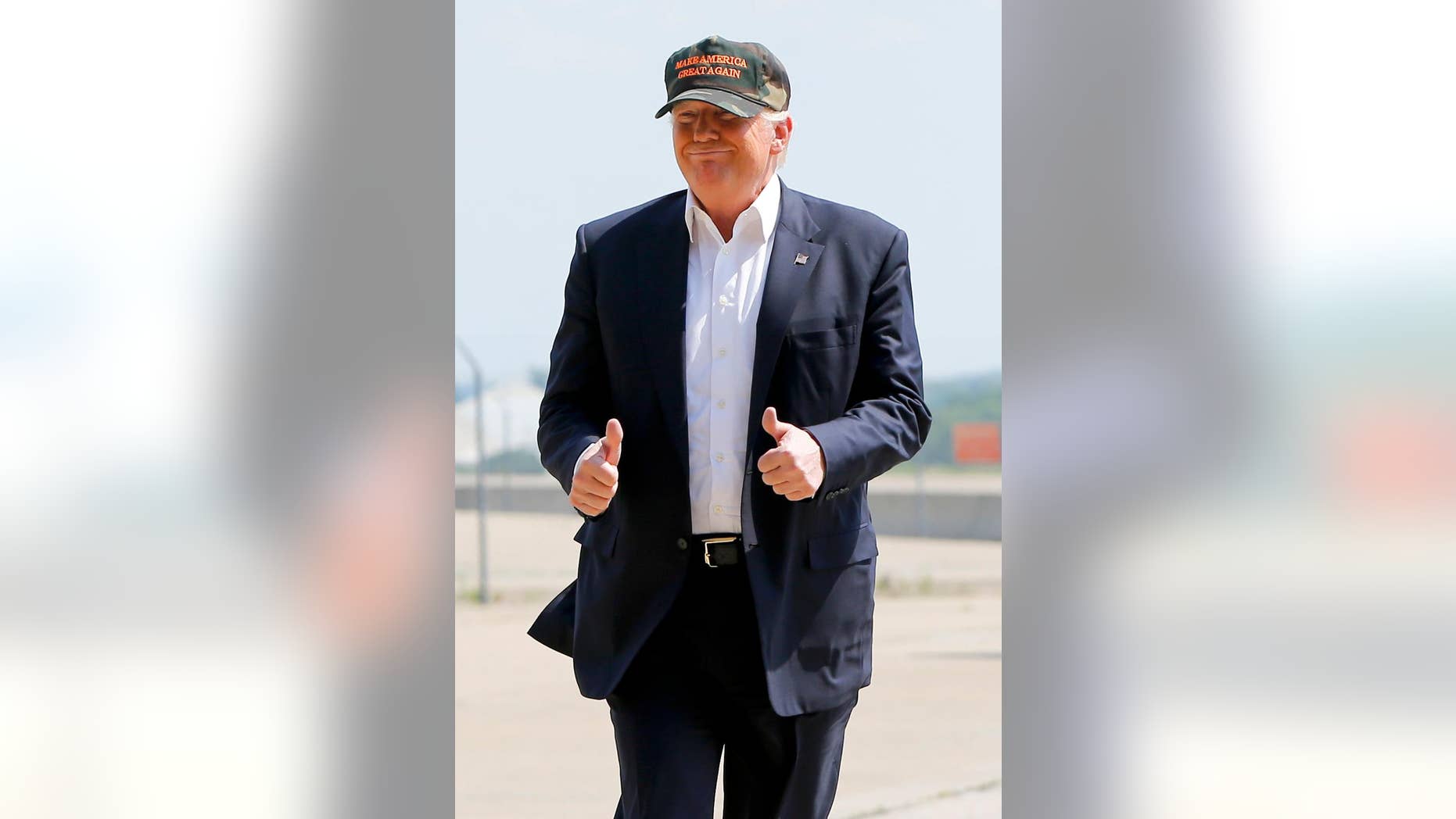 Republican presidential candidate Donald Trump gives a thumbs up as he arrives for a campaign rally, Saturday, June 11, 2016, at a private hanger at Greater Pittsburgh International Airport in Moon, Pa. (AP Photo/Keith Srakocic)