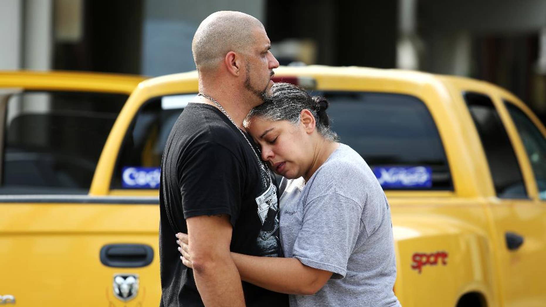 Ray Rivera, left, a DJ at Pulse Orlando nightclub, is consoled by a friend, outside of the Orlando Police Department after a shooting involving multiple fatalities at the nightclub, Sunday, June 12, 2016, in Orlando, Fla. (Joe Burbank/Orlando Sentinel via AP) MAGS OUT; NO SALES; MANDATORY CREDIT