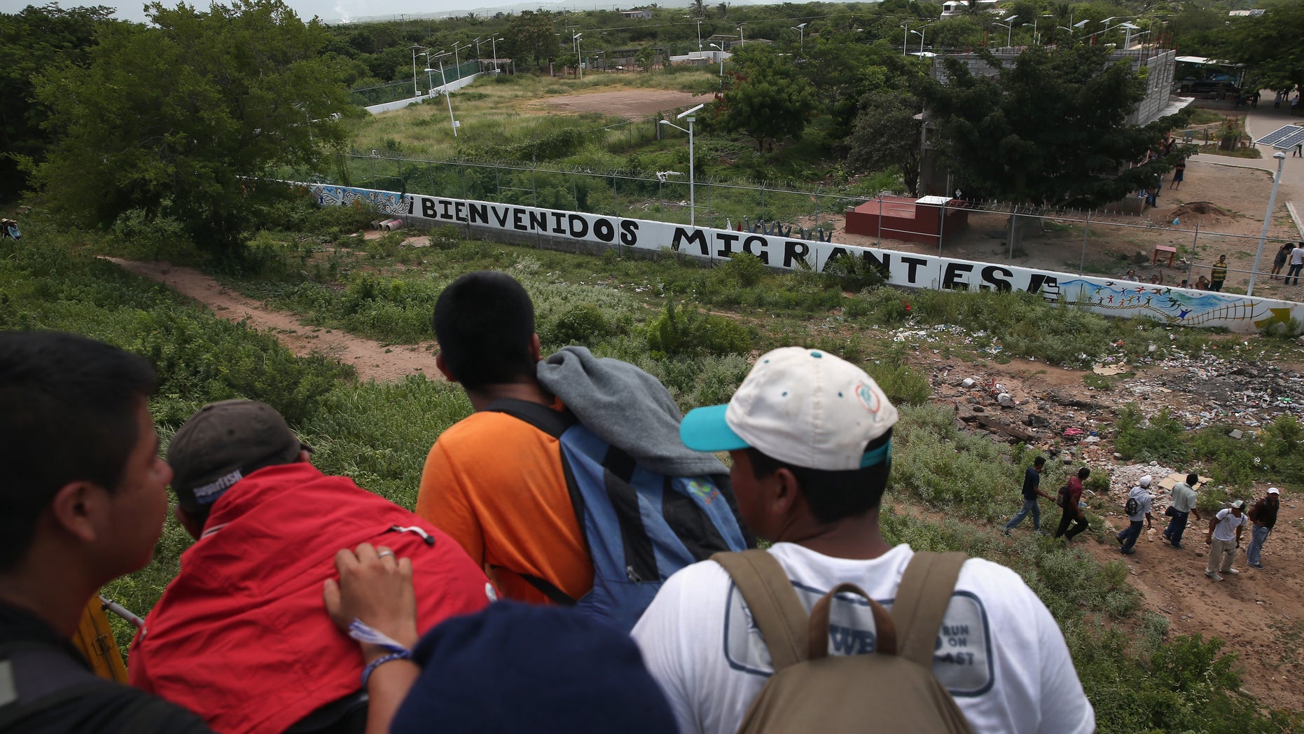 Central American immigrants arrive on top of a freight train to the Hermanos en el Camino immigrant shelter on August 6, 2013 in Ixtepec, Mexico.