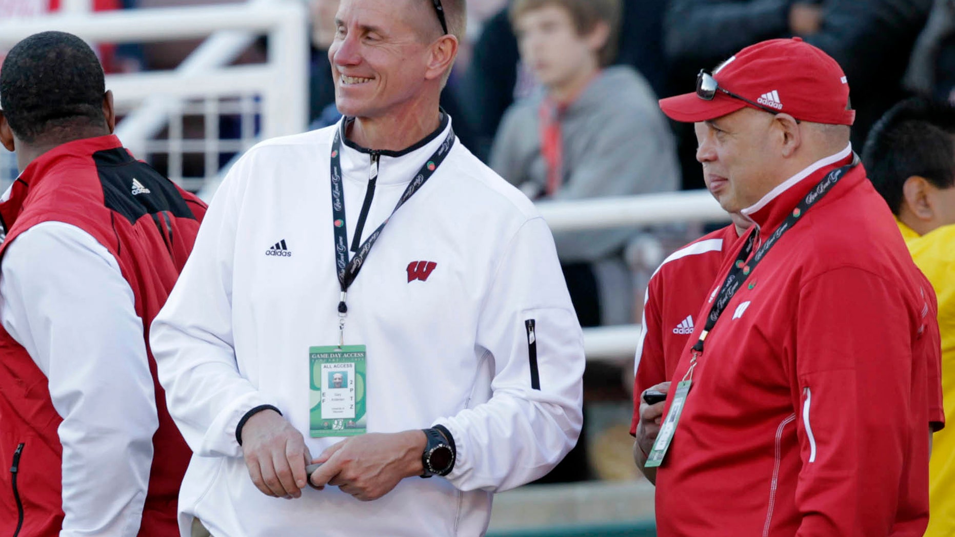 In this photo taken Jan. 1, 2013, the Wisconsin new football coach Gary Andersen, center, watches from the sidelines with deputy athletic director Sean Frazier during the Rose Bowl football game between the Stanford Cardinals and Wisconsin in Pasadena, Calif. Andersen came into the spring with plenty of starters returning for the three-time defending Big Ten champion Badgers. But Montee Ball is gone, and an Ohio State team that went 12-0 last season is eligible again. (AP Photo/The Wisconsin State Journal, Michael P. King)