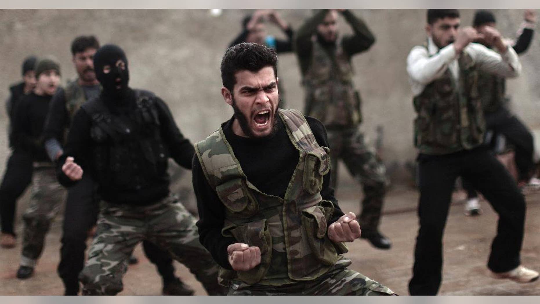 FILE - In this Dec. 17, 2012, file photo, Syrian rebels attend a training session in Maaret Ikhwan near Idlib, Syria. Fewer than 100 Syrian rebels are currently being trained by the U.S. military to fight the Islamic State group, a tiny total for a sputtering program with a stated goal of producing 5,400 fighters a year. The training effort is moving so slowly that critics question whether it can produce enough capable fighters quickly enough to make a difference. Military officials said this past week that they still hope for 3,000 by year’s end. Privately, they acknowledge the trend is moving in the wrong direction. (AP Photo/Muhammed Muheisen, File)