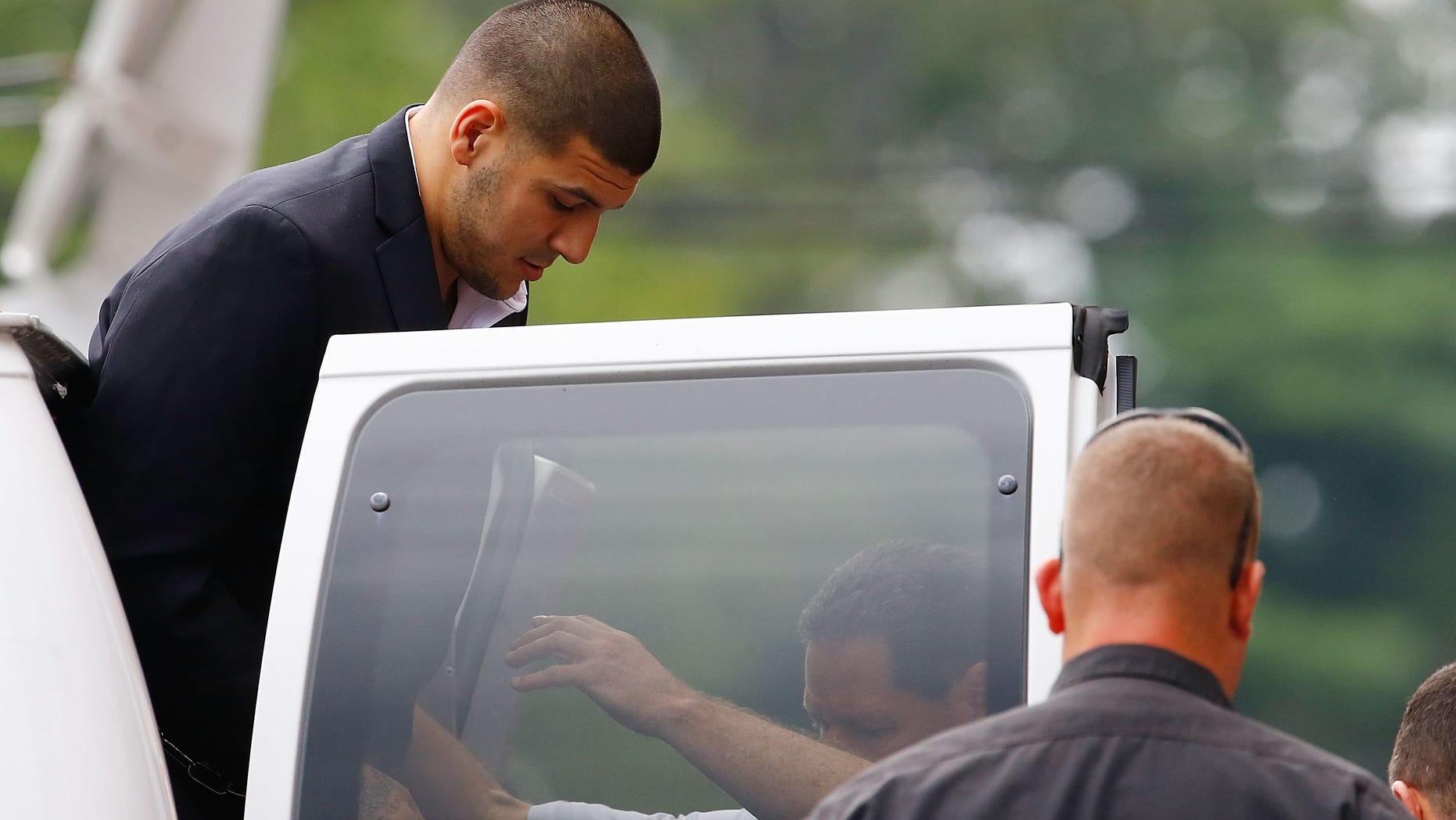 Aaron Hernandez is escorted into Attleboro District Court on August 22, 2013 in North Attleboro, Massachusetts.