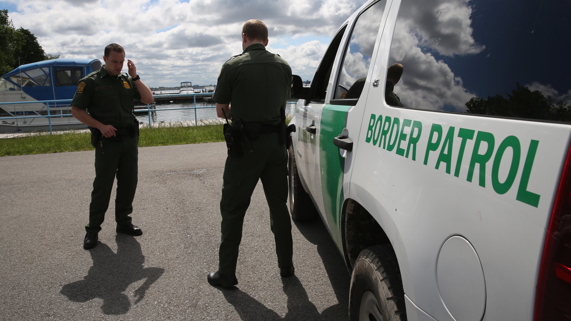 BEAVER ISLAND STATE PARK, NY - JUNE 03: U.S. Border Patrol agents talk while at a marina on the Niagara River at the U.S.-Canada border on June 3, 2013 in Beaver Island State Park, New York. U.S. Customs and Border Protection, which includes the Border Patrol, monitors the 5,525 mile long border, including Alaska, forming the longest international border between two countries in the world. (Photo by John Moore/Getty Images)