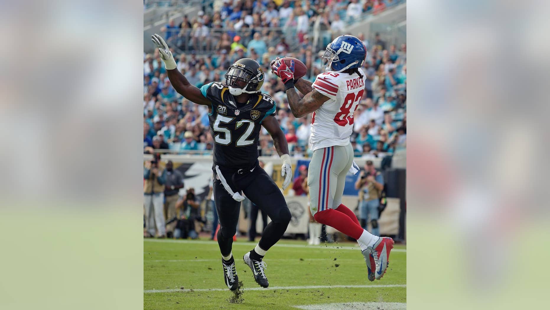 New York Giants wide receiver Preston Parker (83) catches a 3-yard touchdown pass in front of Jacksonville Jaguars outside linebacker J.T. Thomas (52) during the first half of an NFL football game in Jacksonville, Fla., Sunday, Nov. 30, 2014. (AP Photo/Phelan M. Ebenhack)
