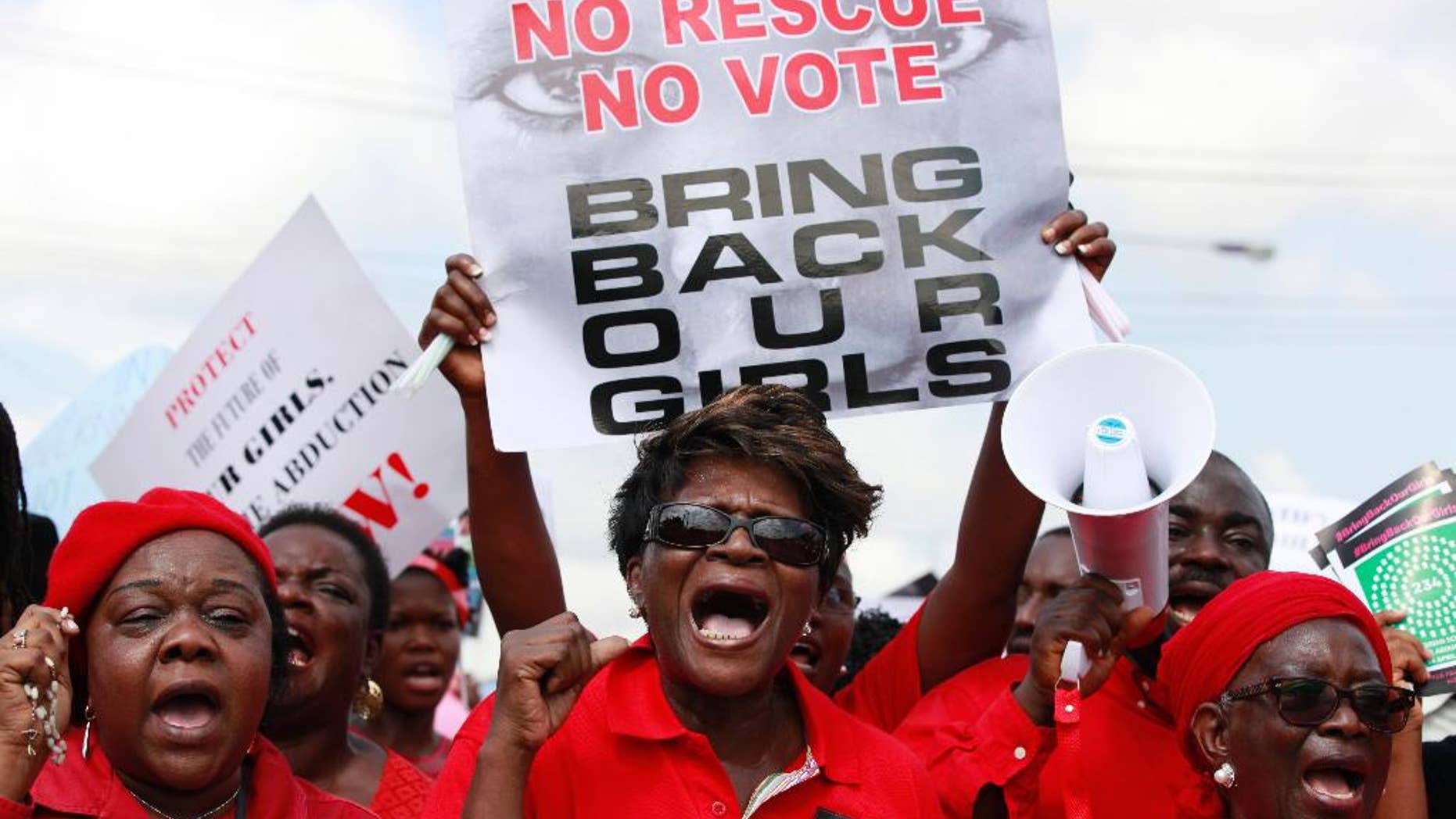 FILE- In this Monday, May 5, 2014 file photo, women attend a demonstration in Lagos calling on the government to rescue kidnapped school girls of a government secondary school in Chibok, Nigeria. The first of Nigeria’s kidnapped “Chibok girls” to make it home Thursday Sept. 25, 2014, after being released by her Islamic extremist captors spent a tortured night, tossing and turning and screaming “They will kill me! They will kill me!” So says the Rev. Enoch Mark, who stayed up through Thursday night with the traumatized young woman. She appears to be the daughter of a Chadian carpenter who moved to the town of Chibok many years ago, according to interviews by The Associated Press. (AP Photo/ Sunday Alamba, File)