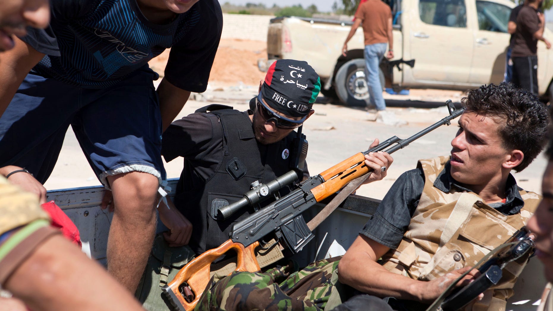Libyan rebels are seen in the back of a pick-up truck headed for the frontline near Zawiya in western Libya, Saturday, Aug. 13, 2011.