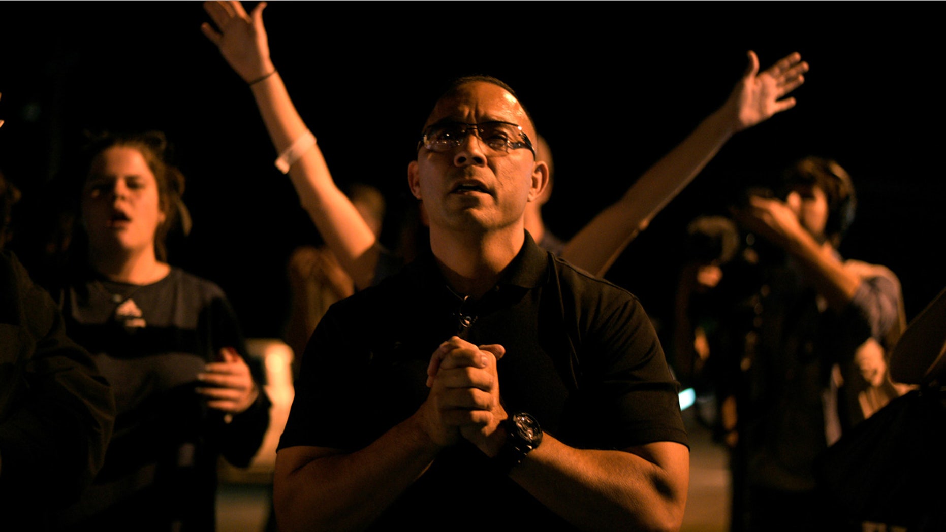 Community leader Mike Gonzales attends a candle light vigil after a mass shooting at the First Baptist Church in Sutherland Springs
