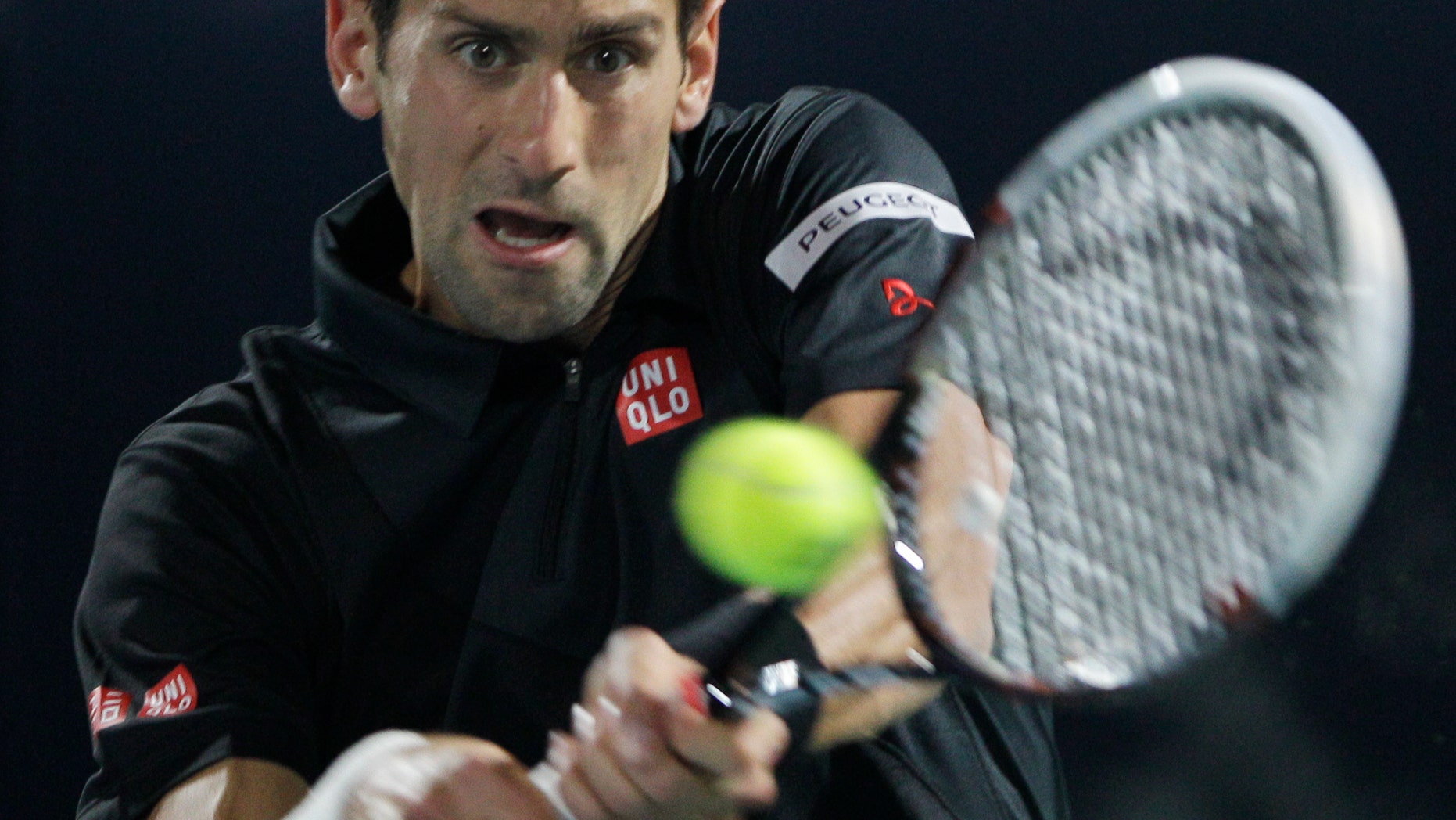 Novak Djokovic of Serbia returns the ball to Spain's Roberto Bautista Agut during the third day of the Dubai Tennis Championships in Dubai, United Arab Emirates, Wednesday, Feb. 26, 2014. (AP Photo/Kamran Jebreili)