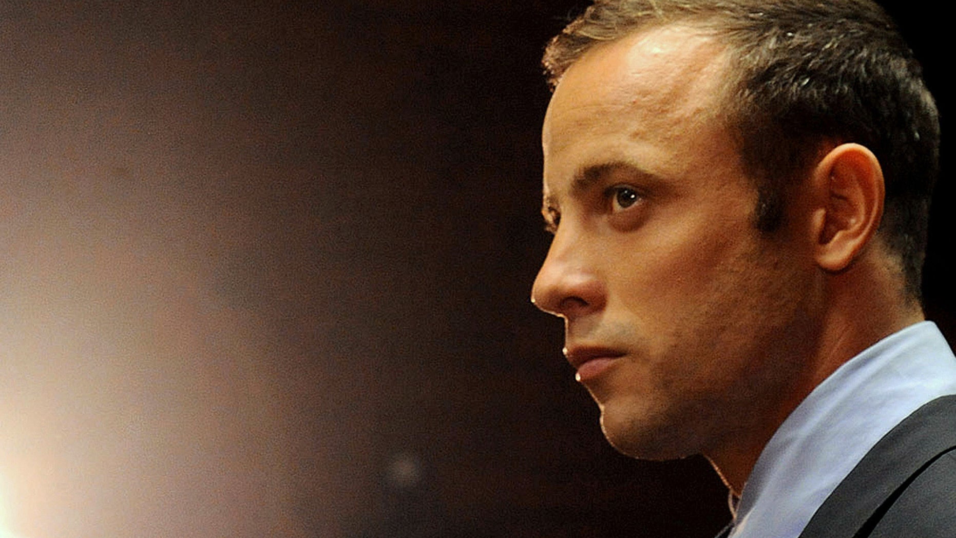 FILE - In this photo taken Friday, Feb. 26, 2013 file photo, Olympic athlete, Oscar Pistorius appears in court for his bail hearing after being charged with the shooting of his girlfriend, Reeva Steenkamp, in Pretoria, South Africa. Oscar Pistorius and Caster Semenya have been left off a list of athletes to receive funding by the South African Olympic Committee ahead of the 2016 Rio Games. South African Sports Confederation and Olympic Committee chief executive Tubby Reddy says Pistorius wasn't included on the Operation Excellence support program because of his decision not to compete this year to concentrate on his murder trial. He's accused of shooting his girlfriend. (AP Photo/Themba Hadebe, File)