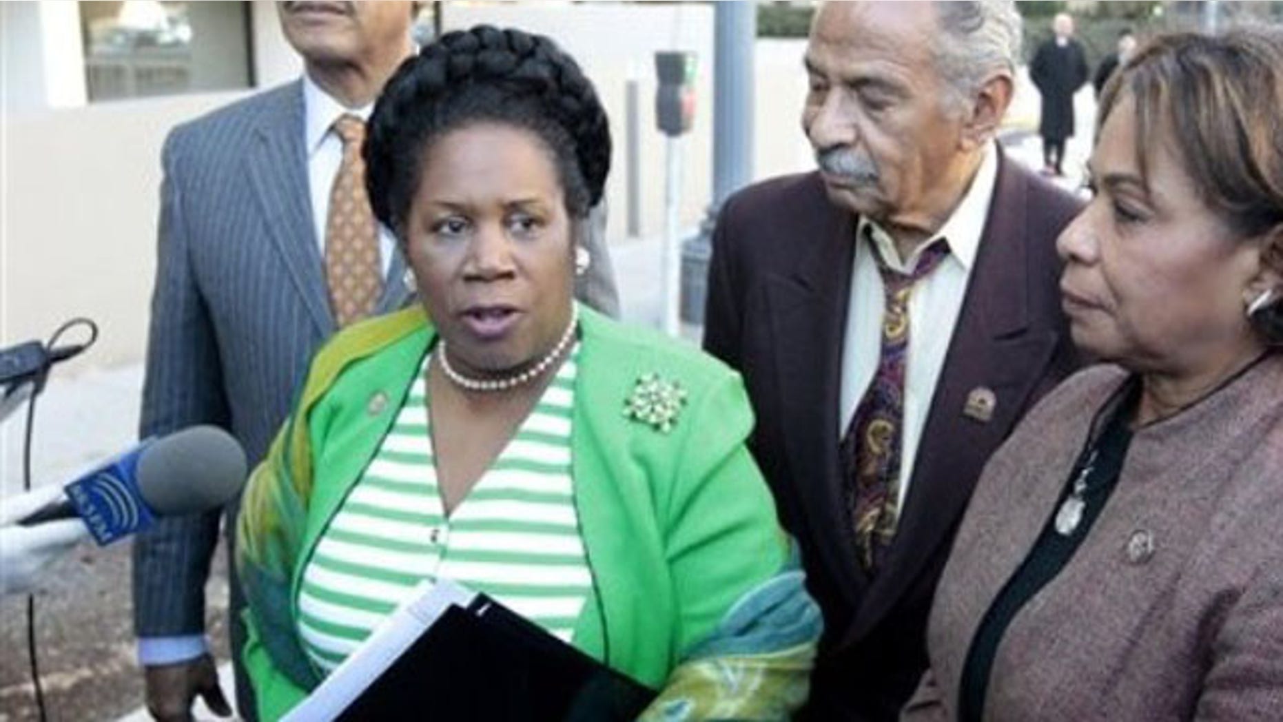 Rep. Sheila Jackson Lee, accompanied by Rep. John Conyers, center, and Rep. Barbara Lee, right, speak with reporters outside the Libyan Embassy in Washington, in this March 1, 2011 file photo.