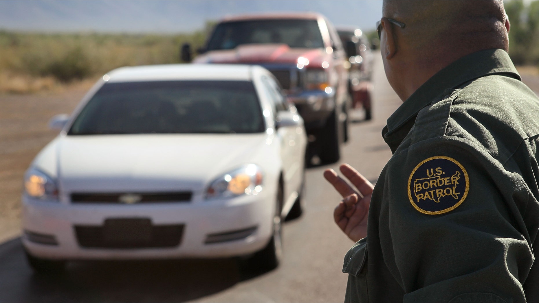 SASABE, AZ - JUNE 01: A Border Patrol agent checks vehicles for illegal immigrants and contraband at a roadside checkpoint June 1, 2010 near Sasabe, Arizona. During the 2009 fiscal year 540,865 undocumented immigrants were apprehended entering the United States illegally along the Mexican border, 241,000 of those were captured in the 262 mile stretch of the border known as the Tucson Sector. (Photo by Scott Olson/Getty Images)