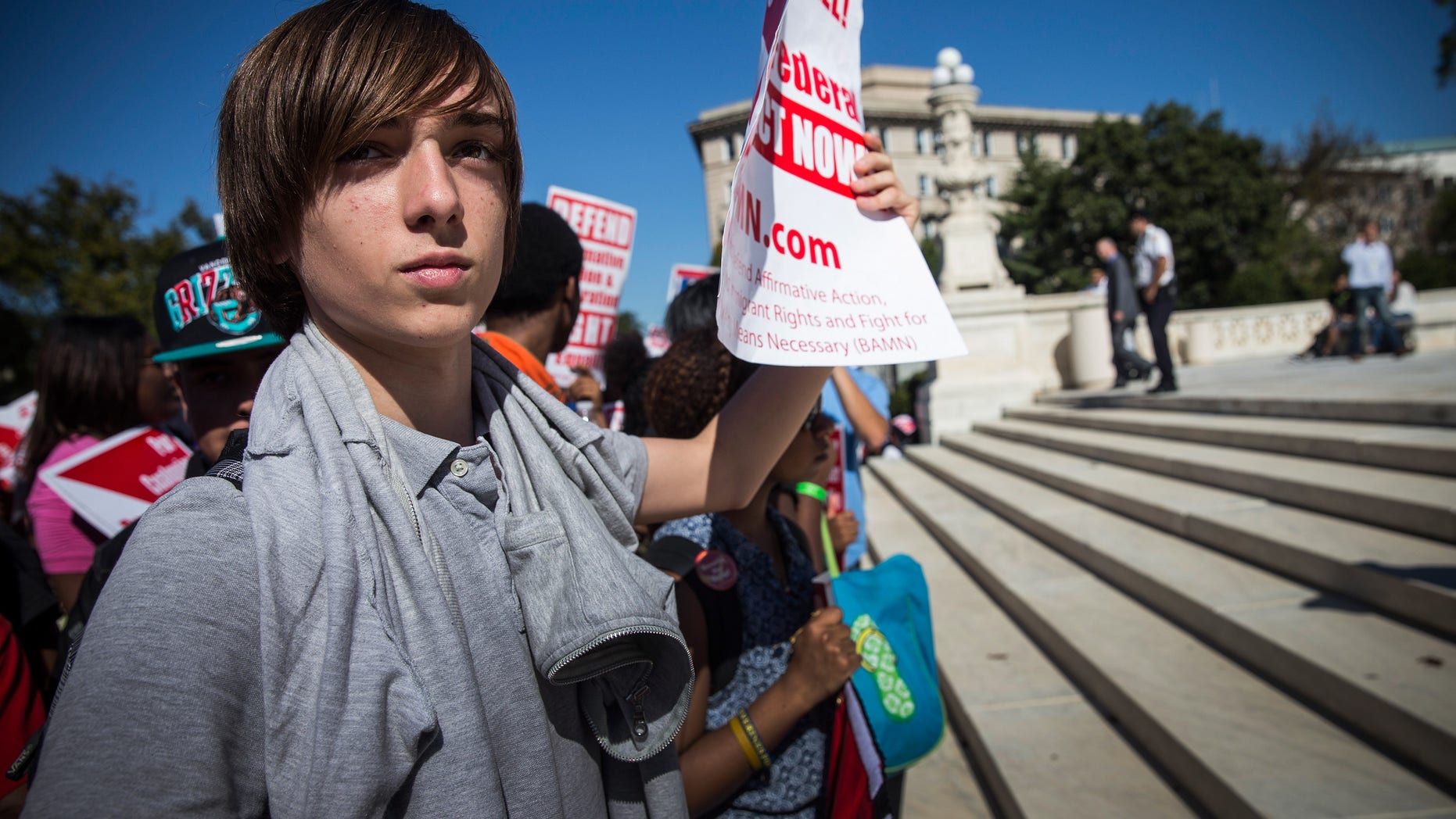 WASHINGTON, DC - OCTOBER 15: A boy protests in support of affirmative action, outside the Supreme Court during the hearing of "Schuette v. Coalition to Defend Affirmative Action" on October 15, 2013 in Washington, DC. The case revolves around affirmative action and whether or not states have the right to ban schools from using race as a consideration in school admissions. (Photo by Andrew Burton/Getty Images)