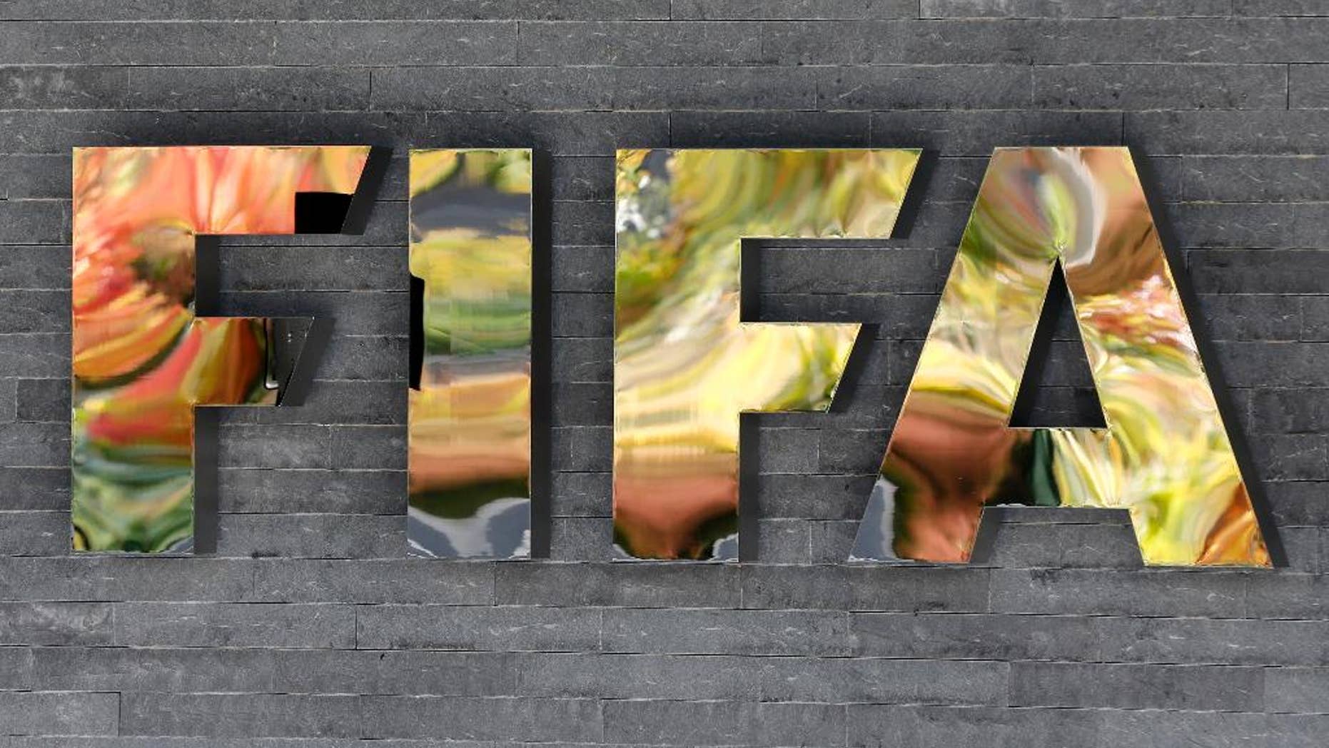 FILE - In this Sept. 25, 2015 file photo, the FIFA logo is fixed on a wall of the FIFA headquarters in Zurich, Switzerland. So far, 16 of FIFA’s 209 member associations have been implicated in an ongoing U.S. Department of Justice investigation of decades of soccer bribery and graft, by virtue of the fact that either their presidents or ex-presidents _ or both in the cases of Brazil, Honduras and Guatemala _ are among those indicted or who have pleaded guilty. (AP Photo/Michael Probst, File)