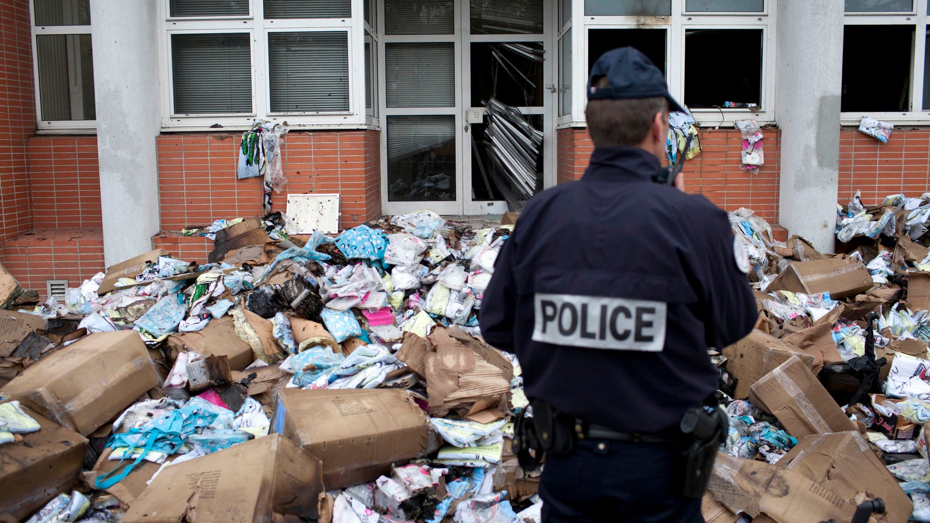 Nov. 2, 2011: A police officer stands in front of the headquarters of satiric French newspaper Charlie Hebdo, that "invited" the Prophet Muhammad as a guest editor this week, in Paris.