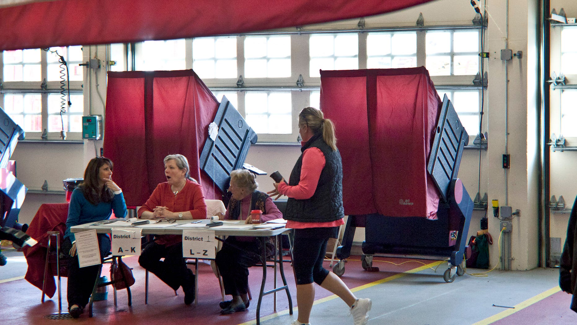 MENDHAM, NJ - NOVEMBER 05: A woman arrives to vote at a polling center in the Mendham Township Fire Department on November 05, 2013 in Mendham, New Jersey. Republican Gov. Chris Christie and Democratic challenger Barbara Buono are the top contenders for governor seat but there are six other independent or third party candidates also running: William Araujo, Jeff Boss, Kenneth Kaplan, Diane Sare, Hank Schroeder and Steven Welzer. (Photo by Kena Betancur/Getty Images)