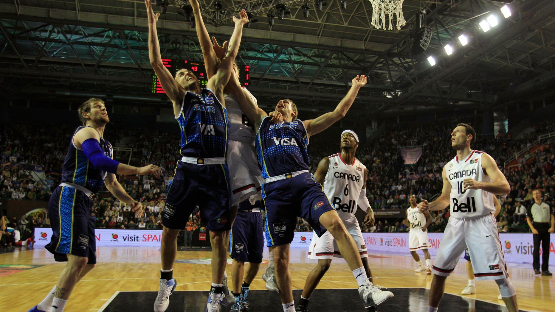 Argentina's players and Canada's players fight for possession during a FIBA Americas Championship basketball game in Mar del Plata, Argentina, Monday, Sept. 5, 2011. The top two finishers of the tournament get an automatic berth in the 2012 London Olympics and the next three advance to the last-chance Olympic qualifier to be held in July 2012. (AP Photo/Martin Mejia)