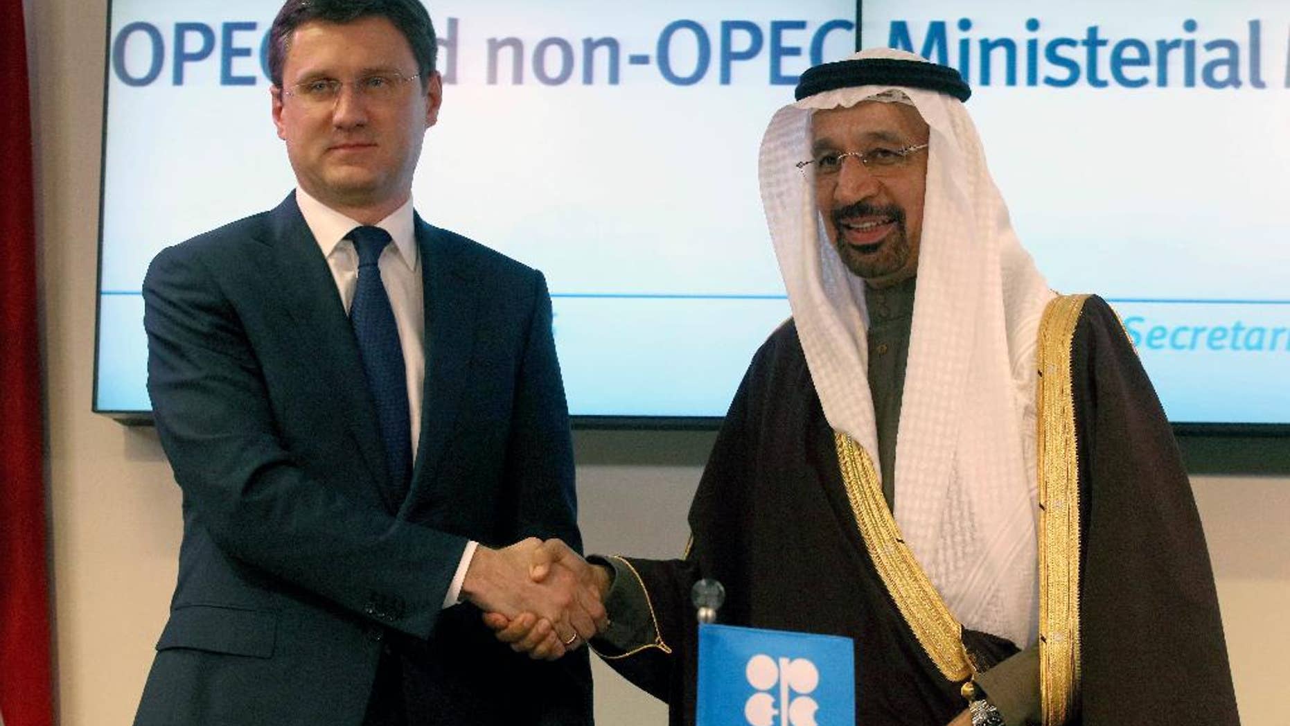 Russian Minister of Energy Alexander Novak, left, shakes hands with Khalid Al-Falih, Minister of Energy, Industry and Mineral Resources of Saudi Arabia after a news conference after a meeting of the Organization of the Petroleum Exporting Countries, OPEC, at their headquarters in Vienna, Austria, Saturday, Dec. 10, 2016. (AP Photo/Ronald Zak)