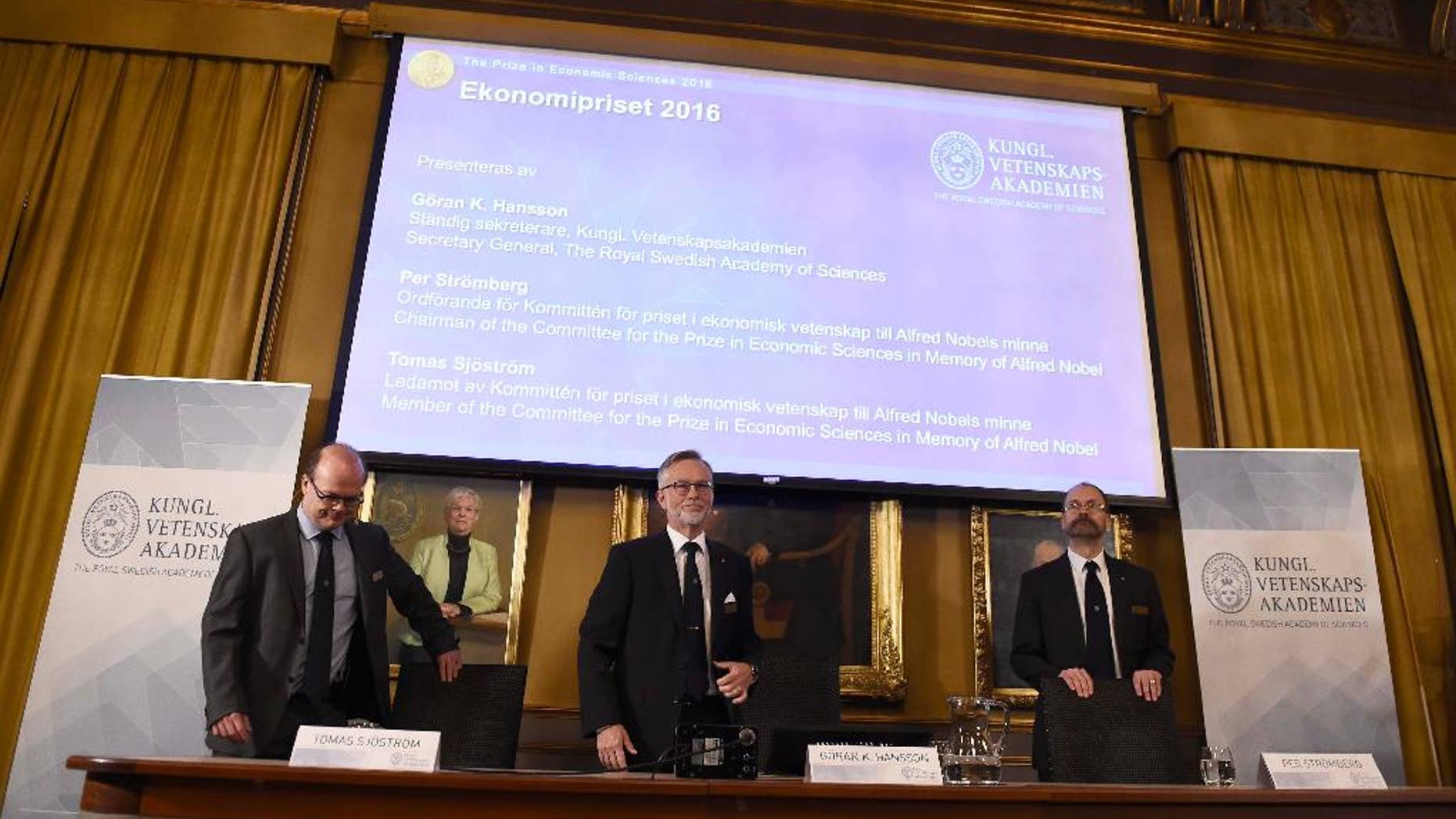 From left, Tomas Sjostrom, member of the Committee for the Prize in Economic Sciences in memory of Alfred Nobel, Goran K. Hansson, Secretary General of the Royal Swedish Academy of Sciences and Per Stromberg, Chairman of the Committee for the Prize in Economic Sciences in memory of Alfred Nobel, arrive for a press conference to announce Oliver Hart and Bengt Holmstrom as the winners of the Nobel Memorial Prize in economic sciences. (Stina Stjernkvist/TT via AP)