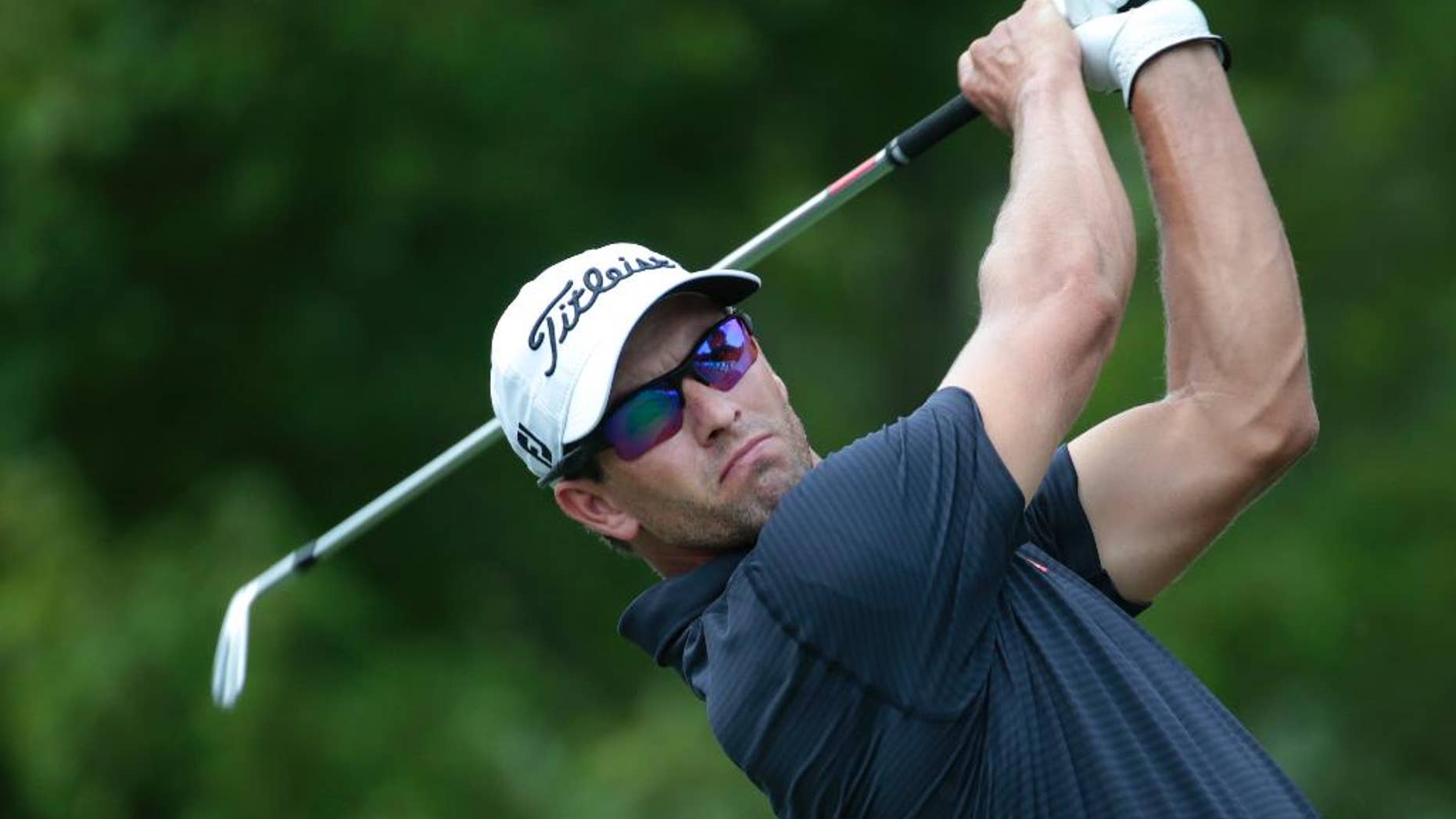 Adam Scott, of Austraila, hits from the tee on the second hole during the third round of play in the Tour Championship golf tournament Saturday, Sept. 13, 2014, in Atlanta. (AP Photo/John Bazemore)